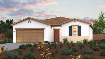 A house with a garage and bushes in front of it.