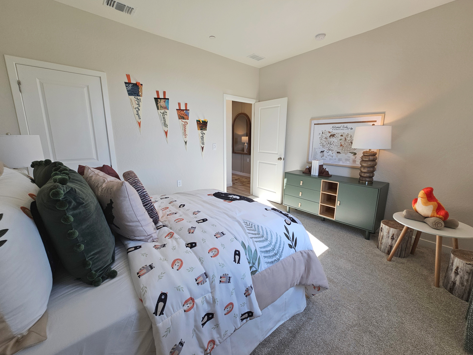 A bedroom with a bed and a table.