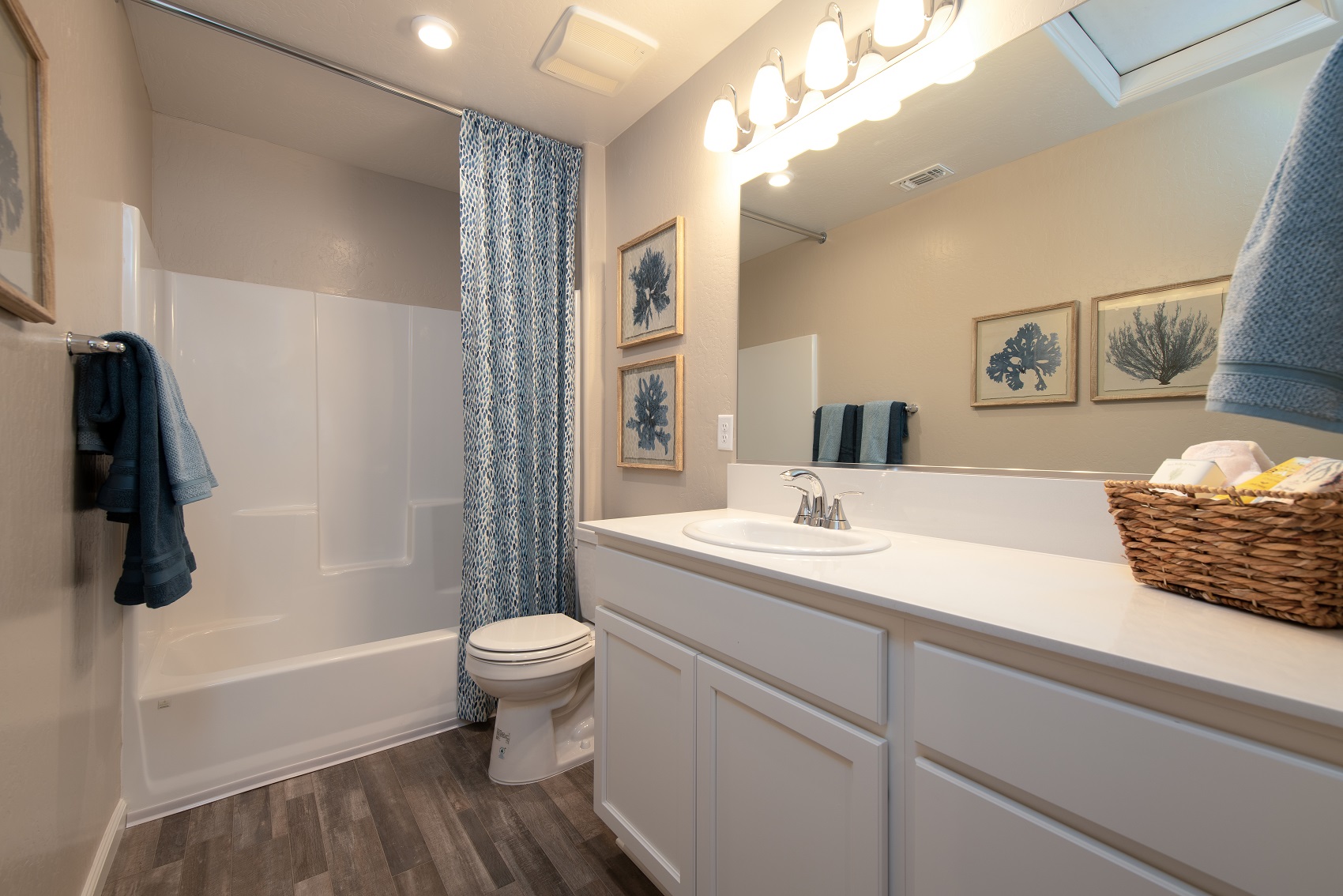 A bathroom with a tub sink and toilet.