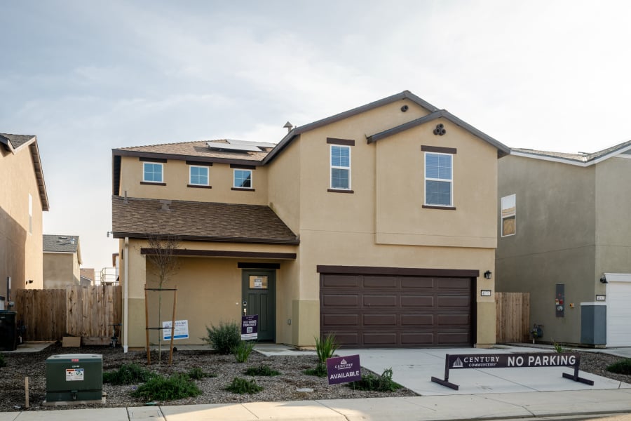 A building with garages and a sign in front of it.