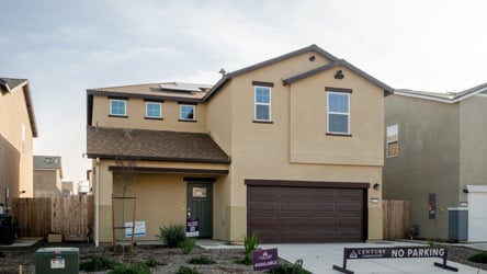 A building with garages and a sign in front of it.