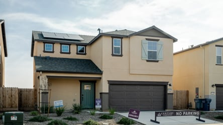 A building with garages and a sign in front of it.