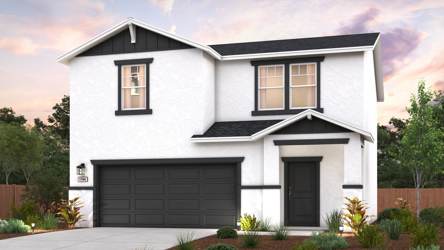 A white house with a garage.