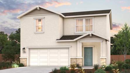 A house with a garage and bushes.