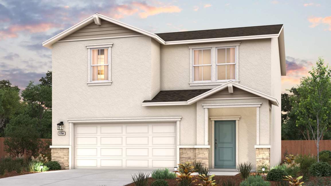 A house with a garage and bushes.