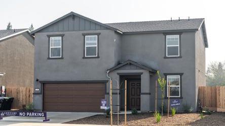 A grey house with a garage.