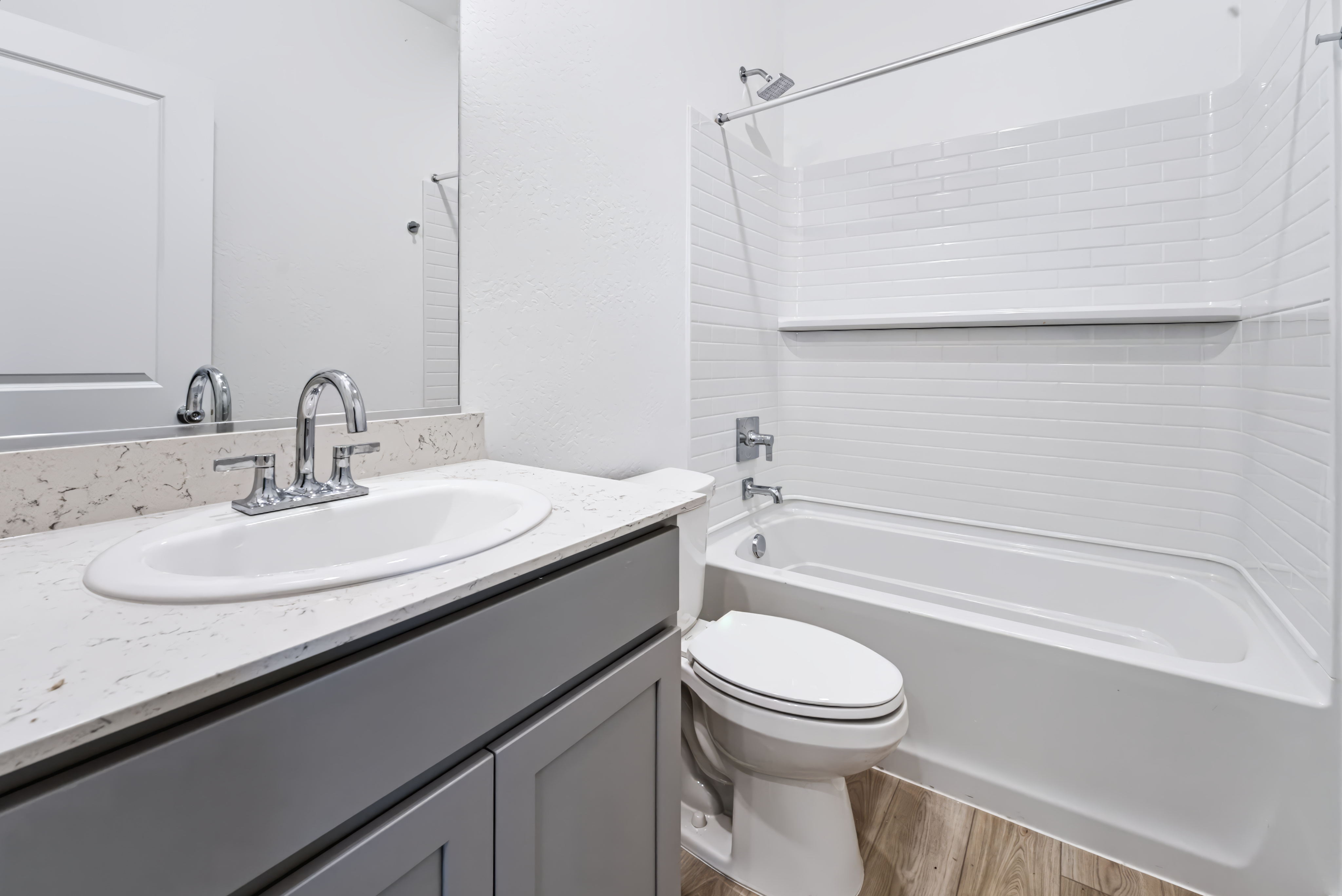A bathroom with a sink toilet and bathtub.