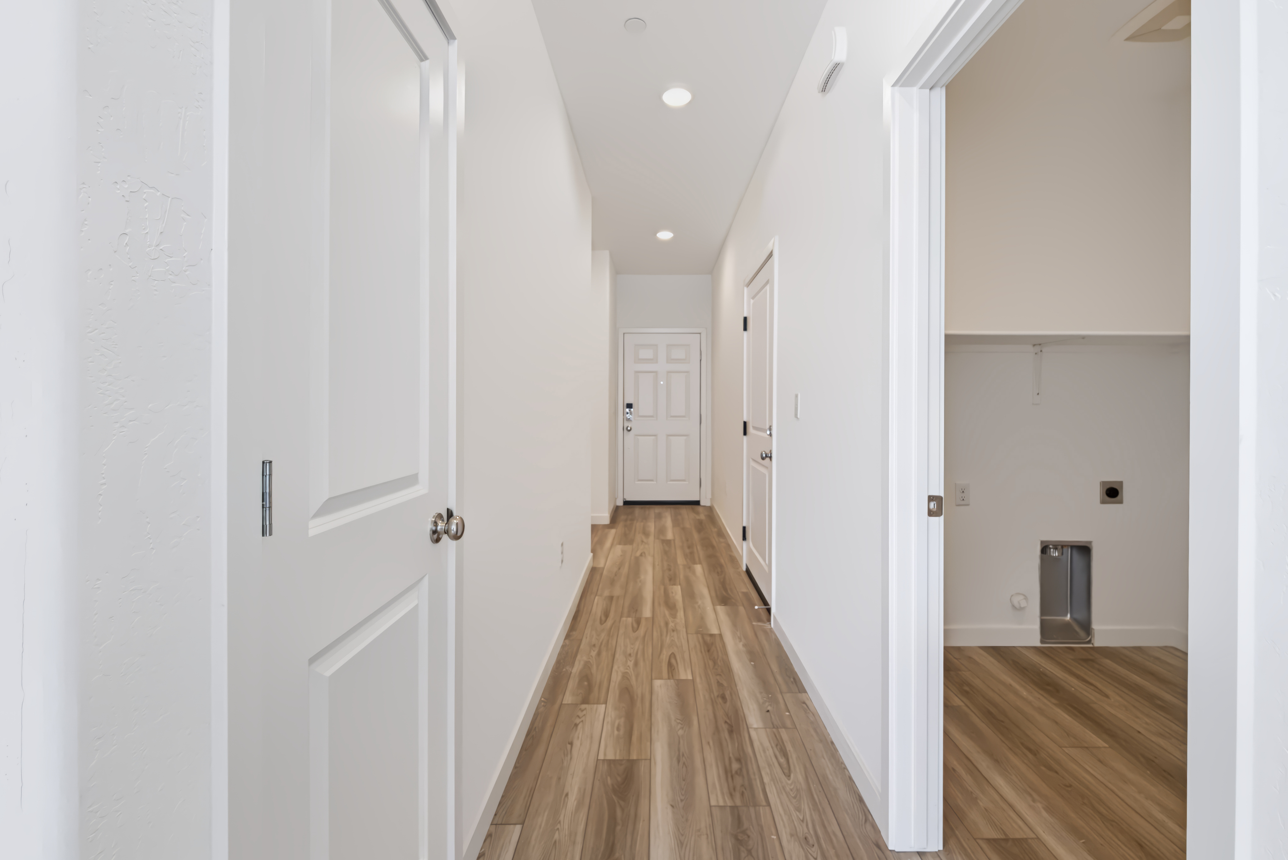 A hallway with white doors.