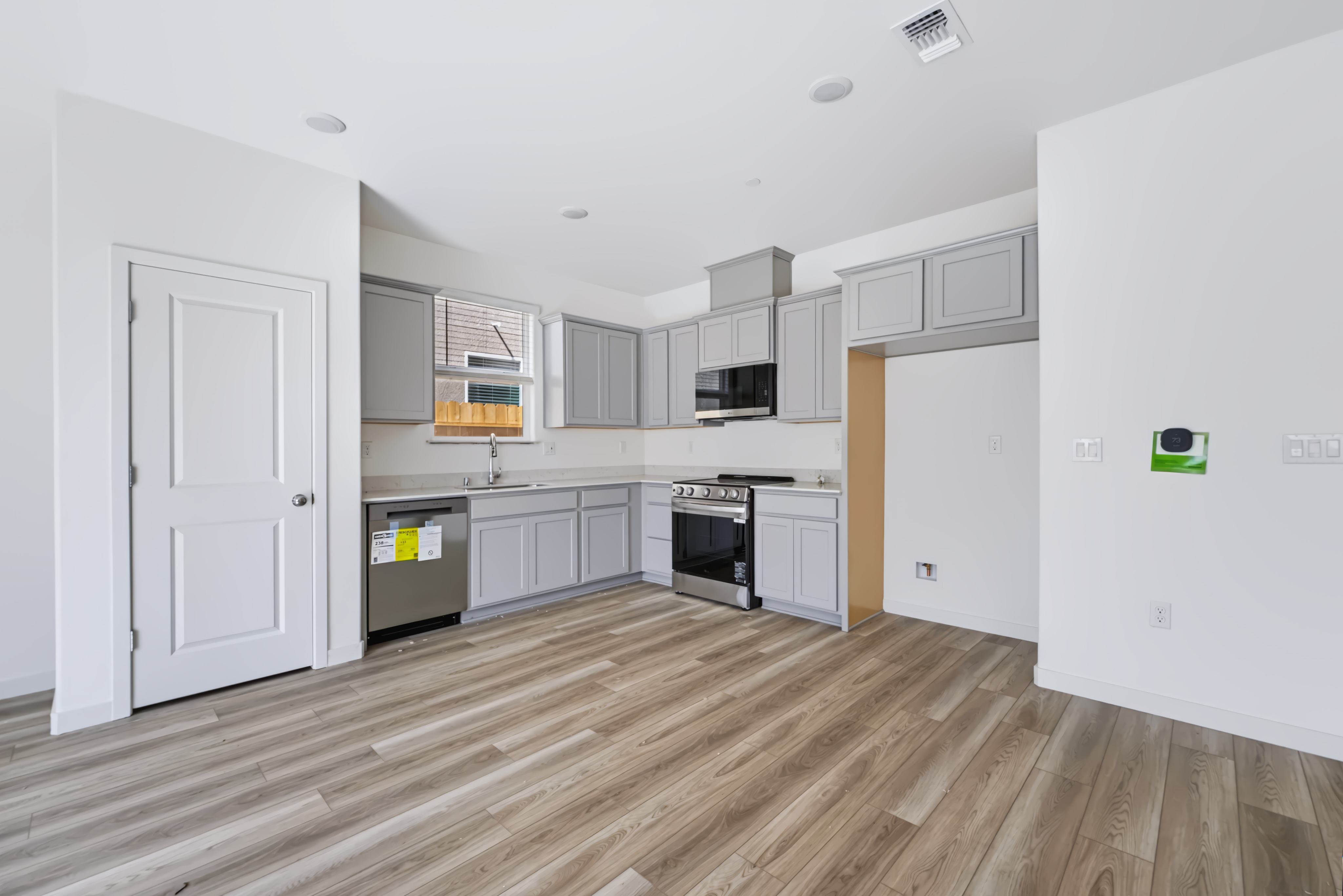 A kitchen with white cabinets.