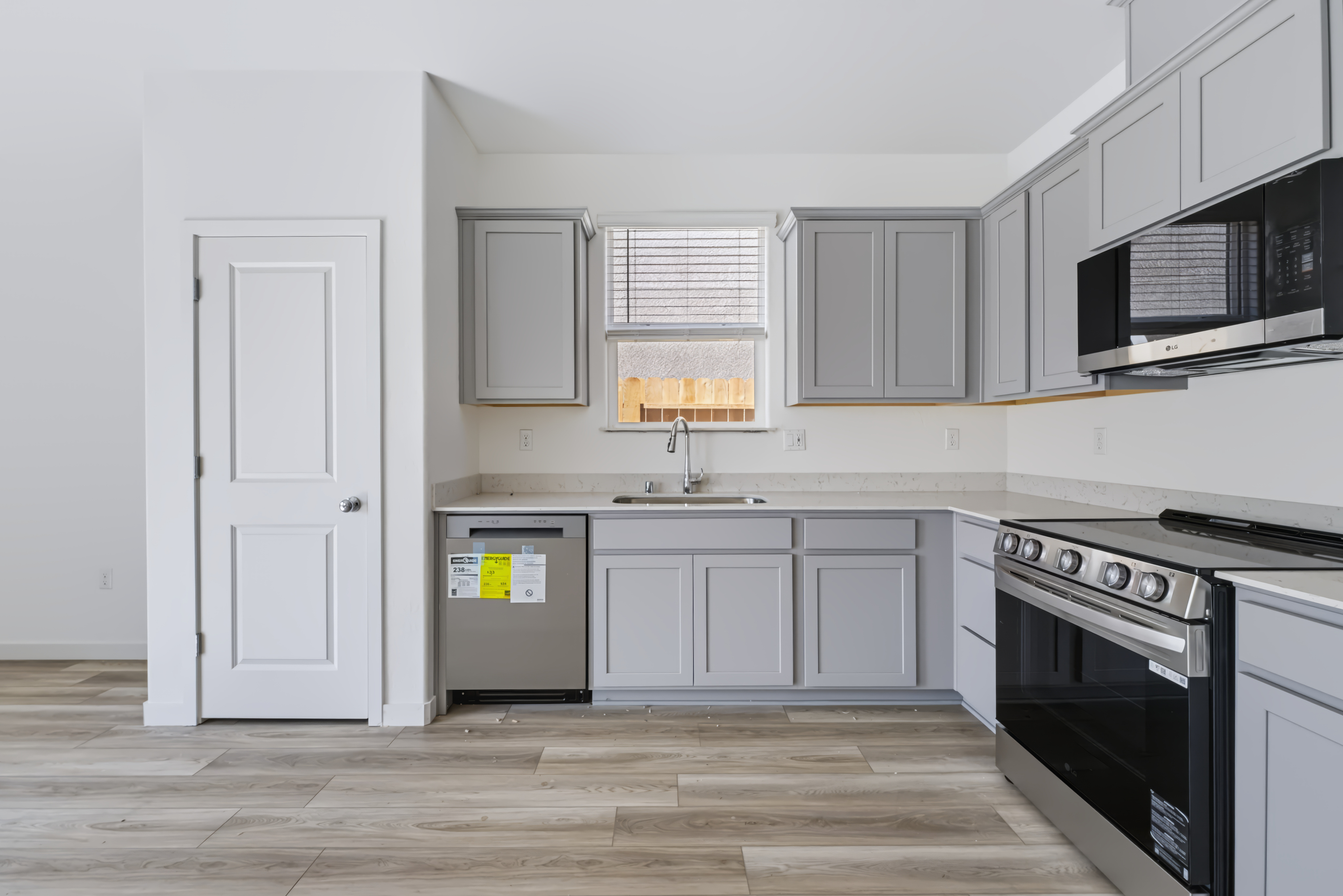 A kitchen with white cabinets.