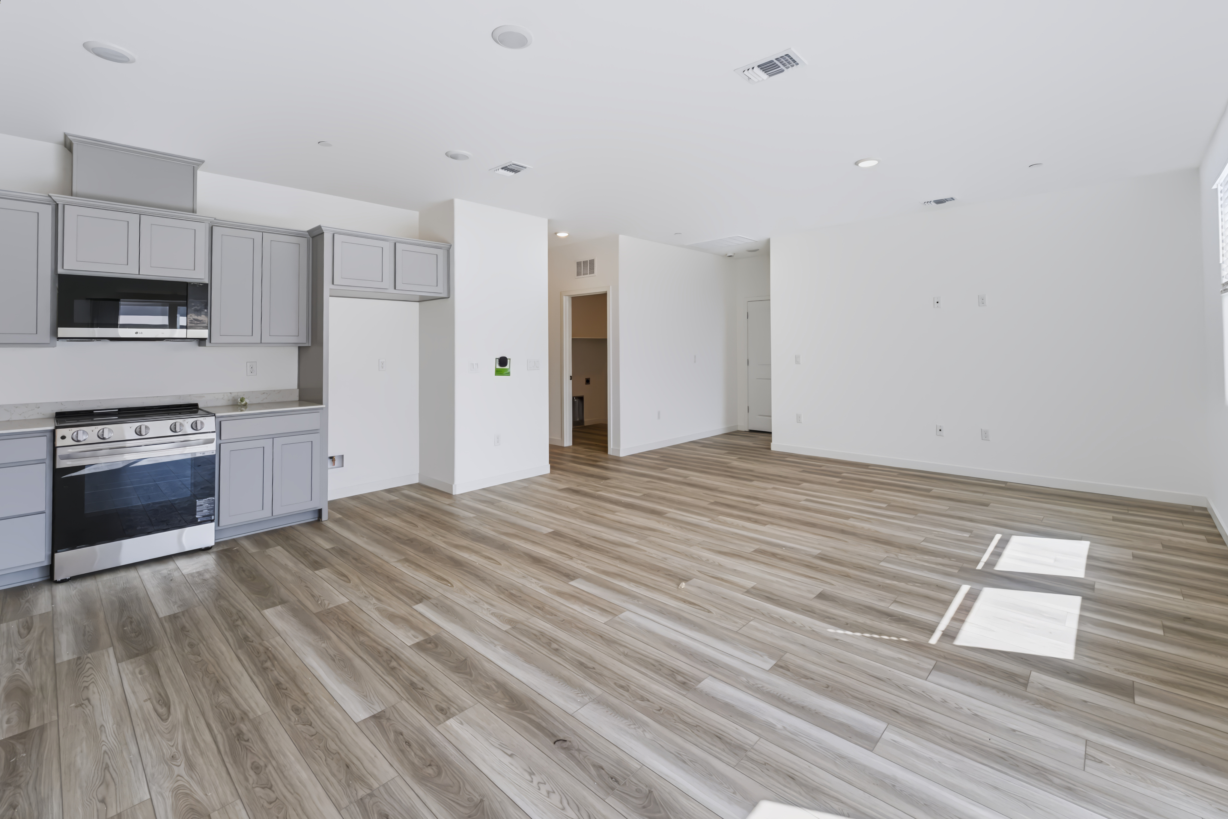 A kitchen with white cabinets.