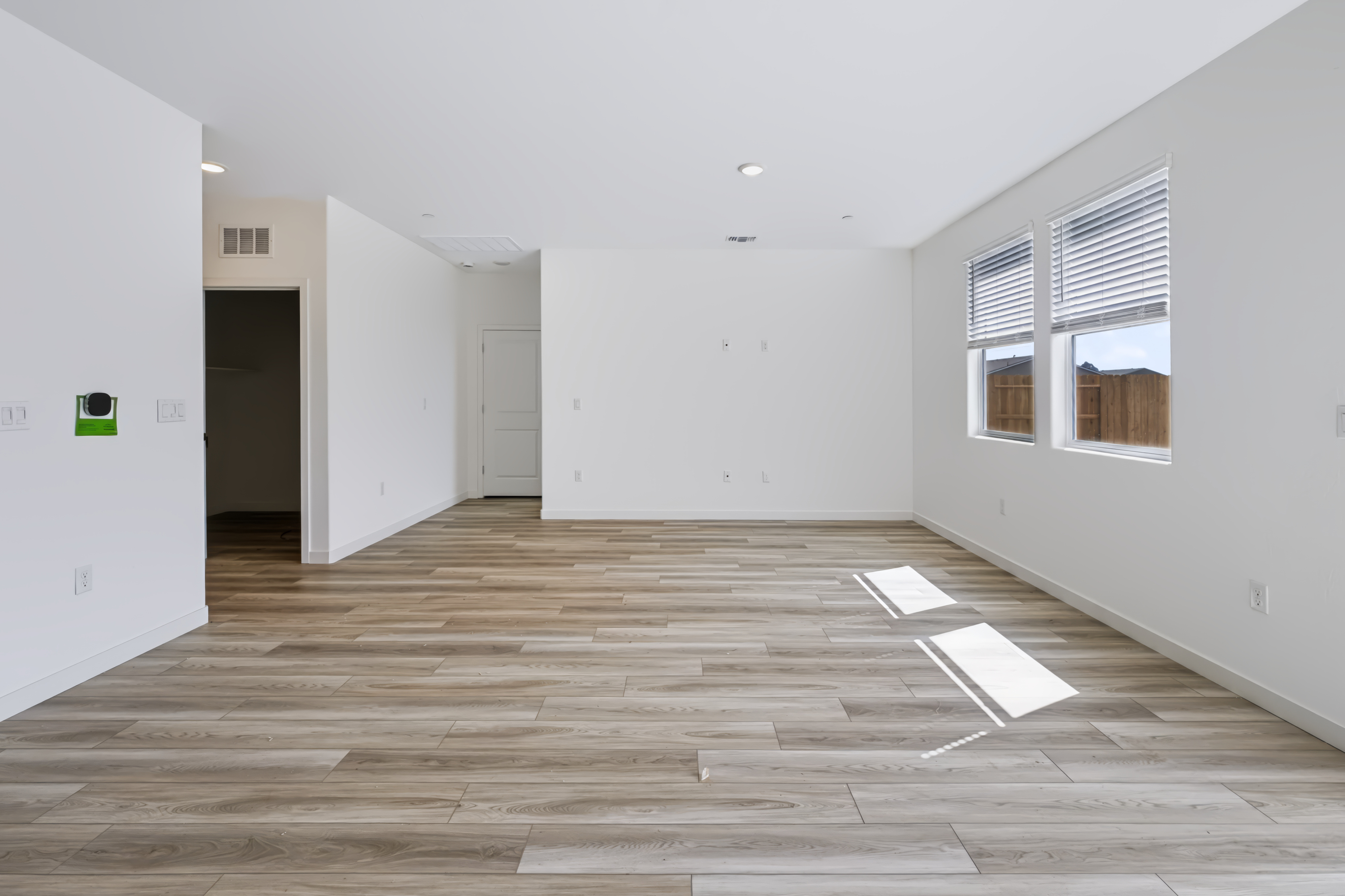 A room with a wood floor and white walls.