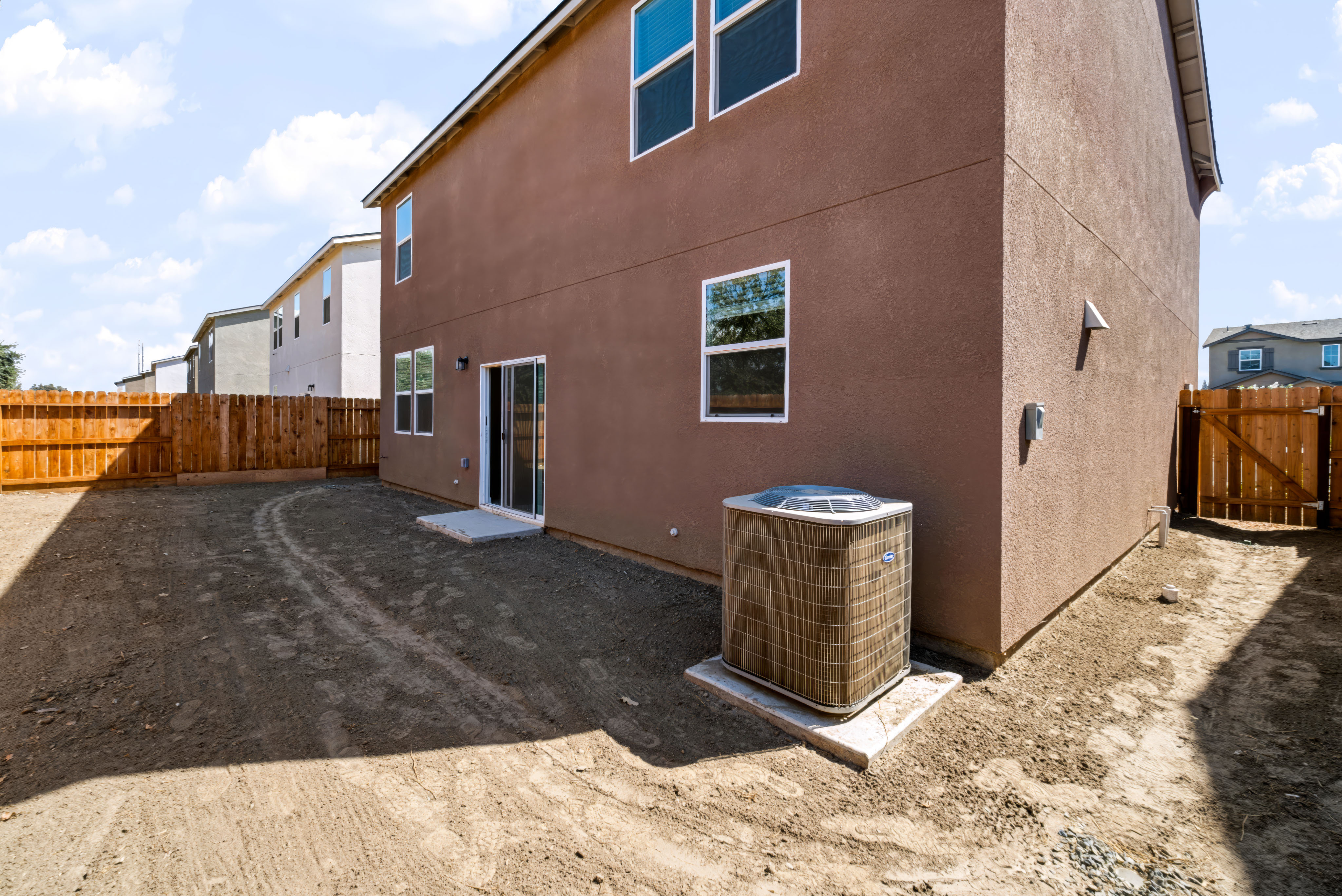 A brick building with a fence around it.