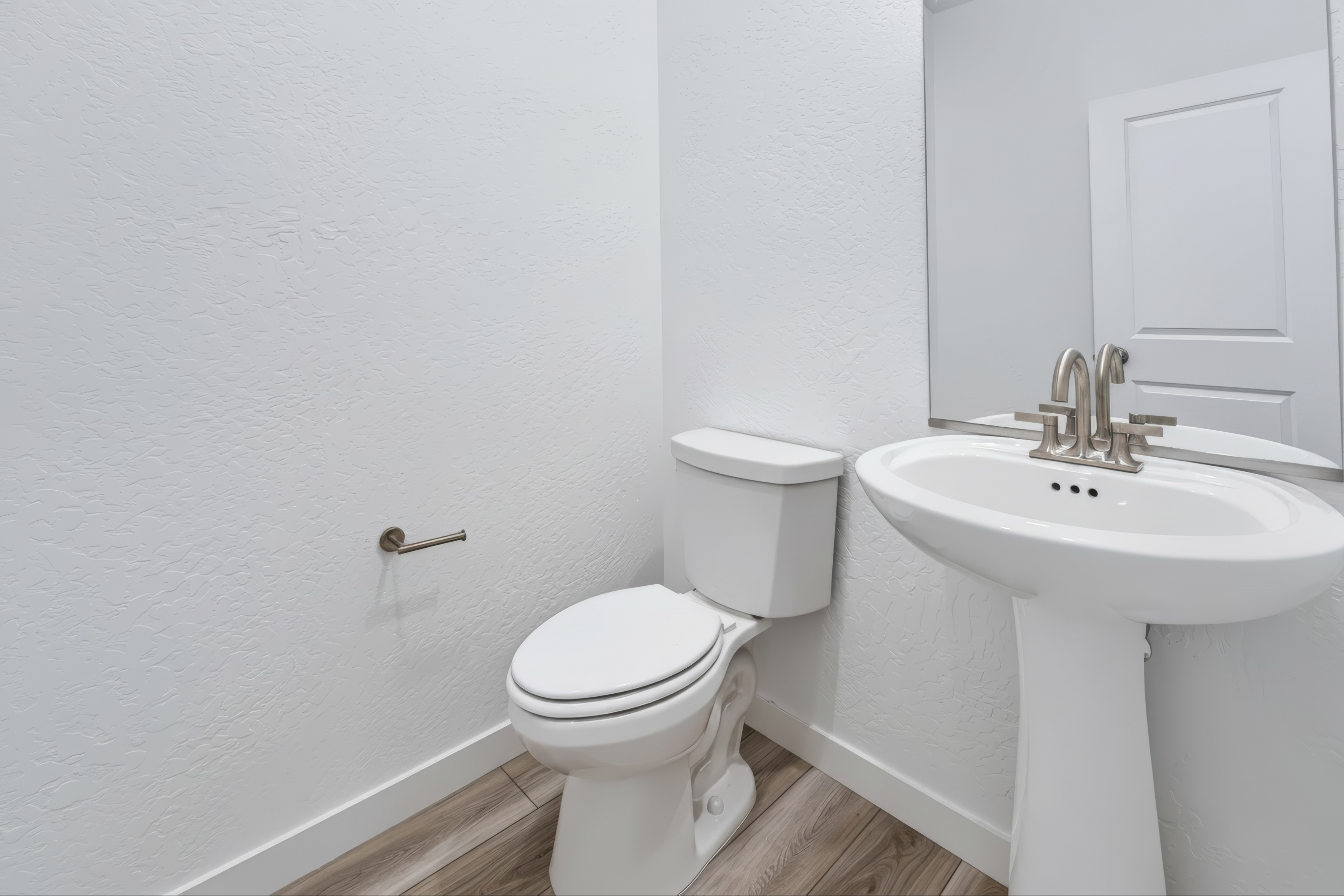 A bathroom with a toilet and sink.
