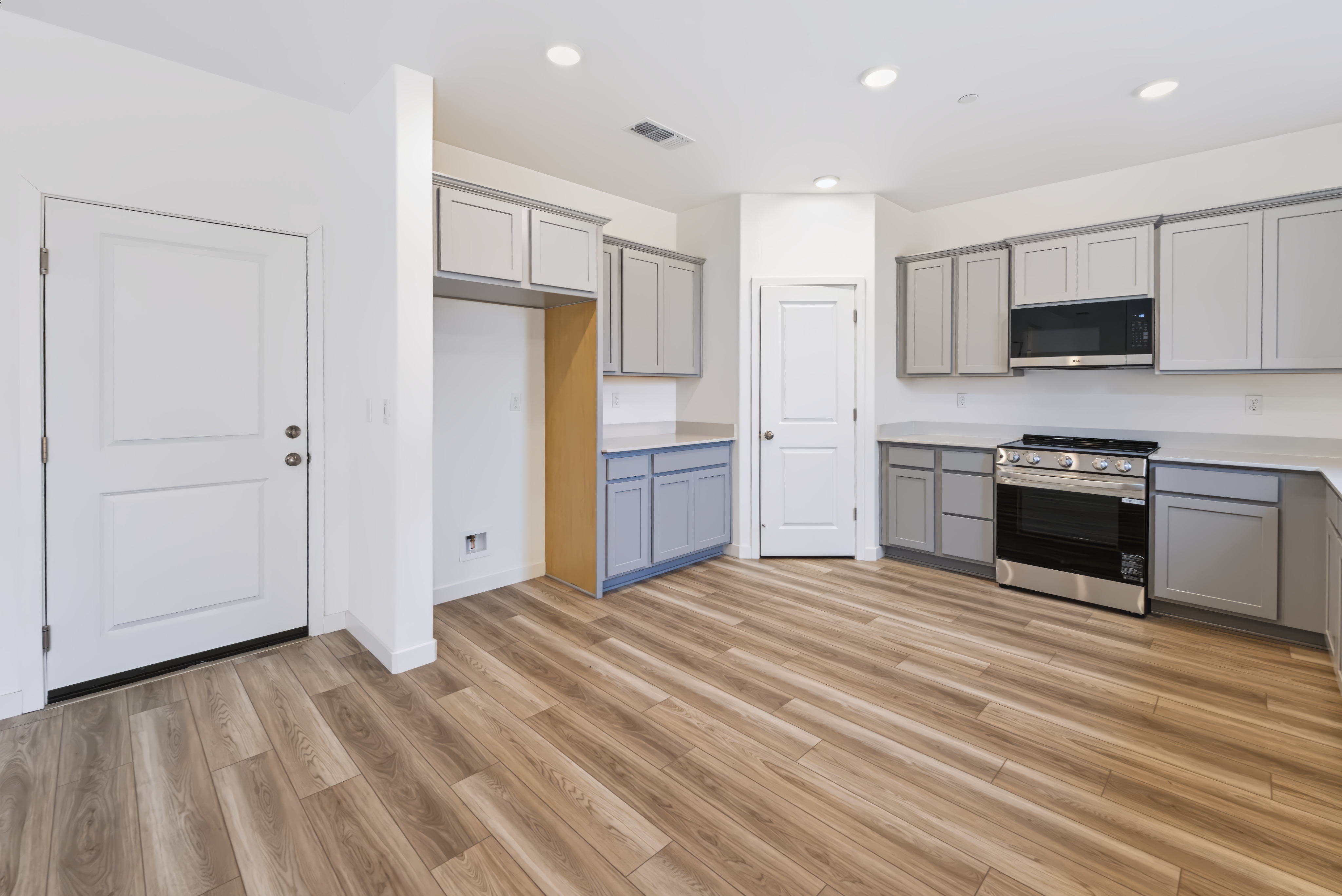 A kitchen with white cabinets.