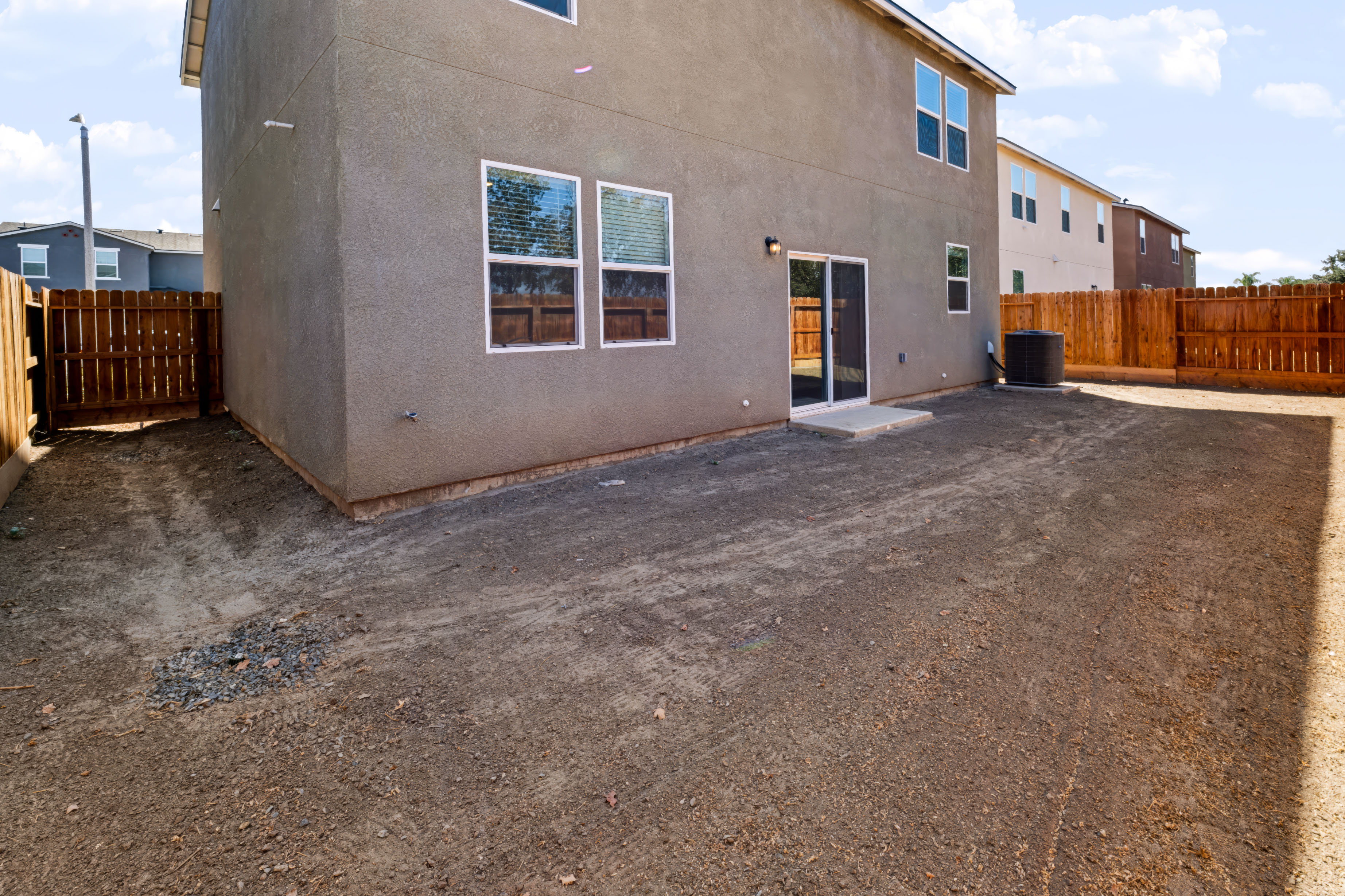A building with a dirt yard.