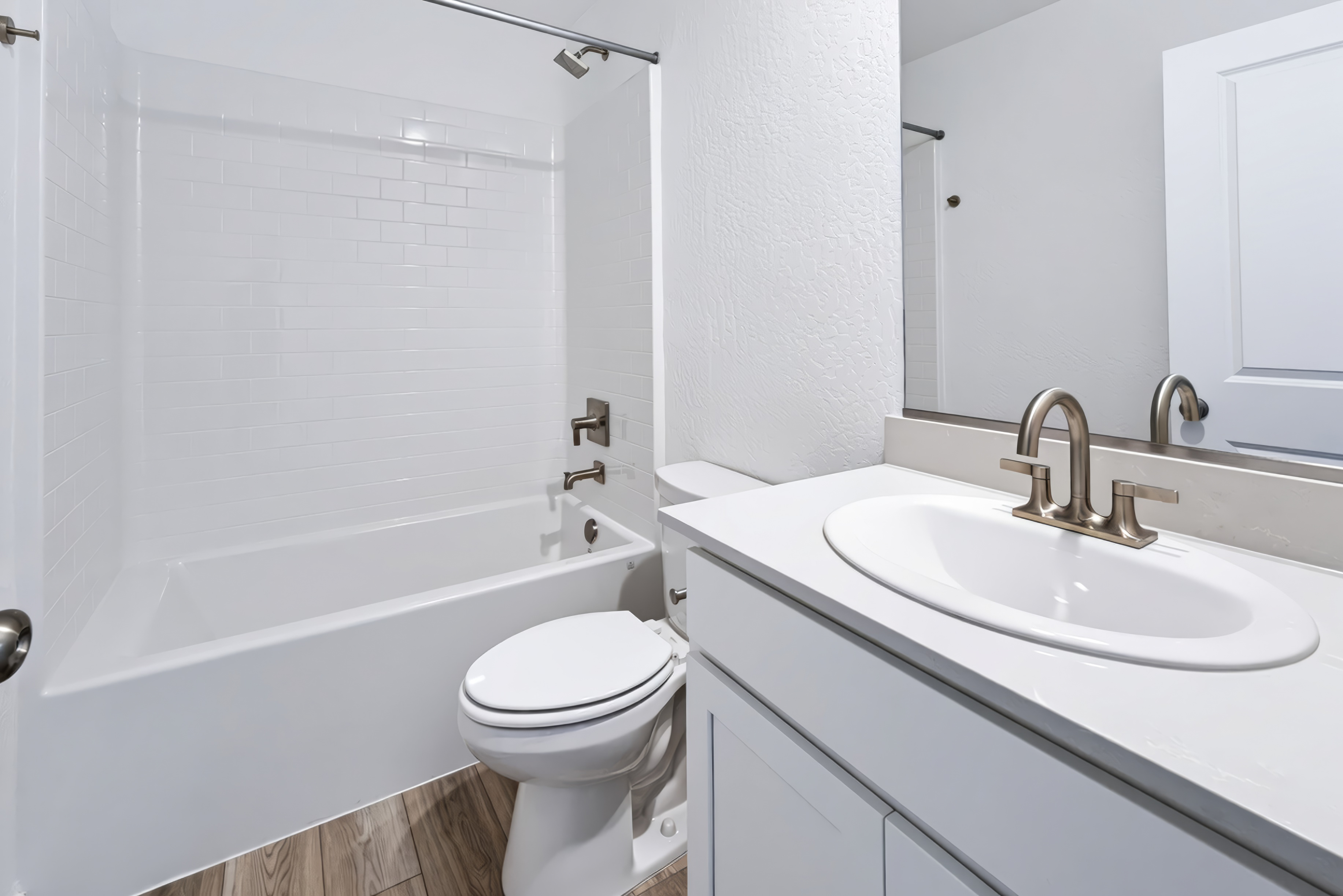 A bathroom with a sink toilet and bathtub.