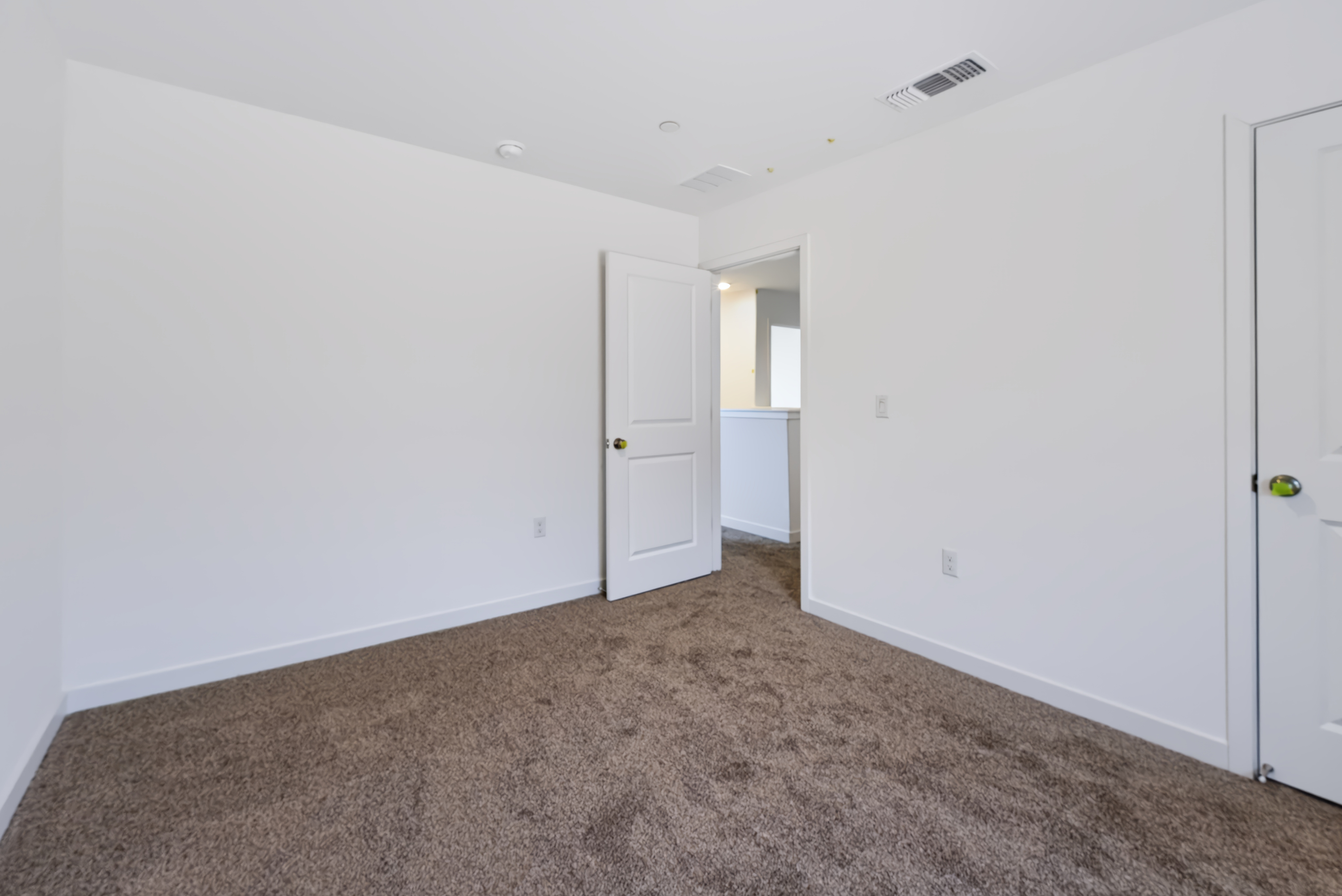 A hallway with white walls.