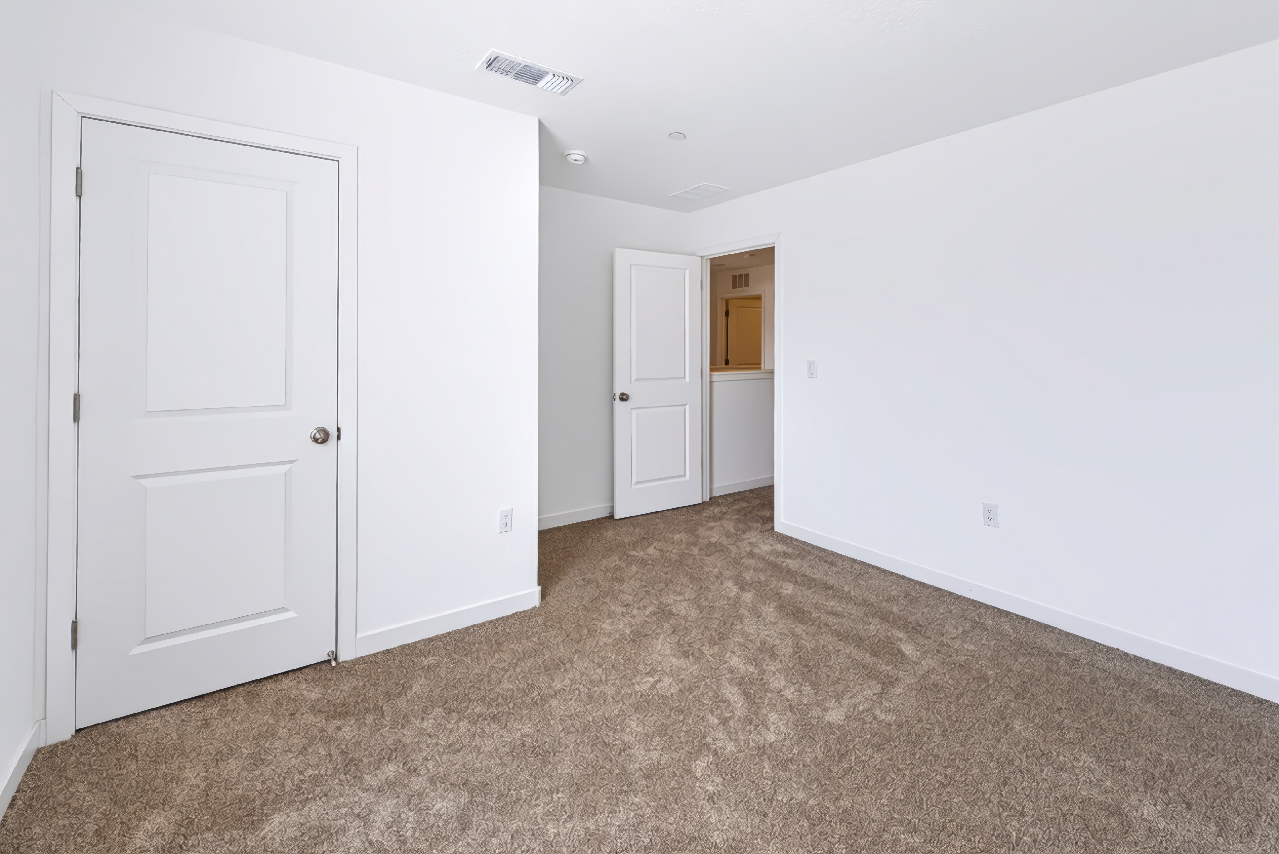 A hallway with white doors.