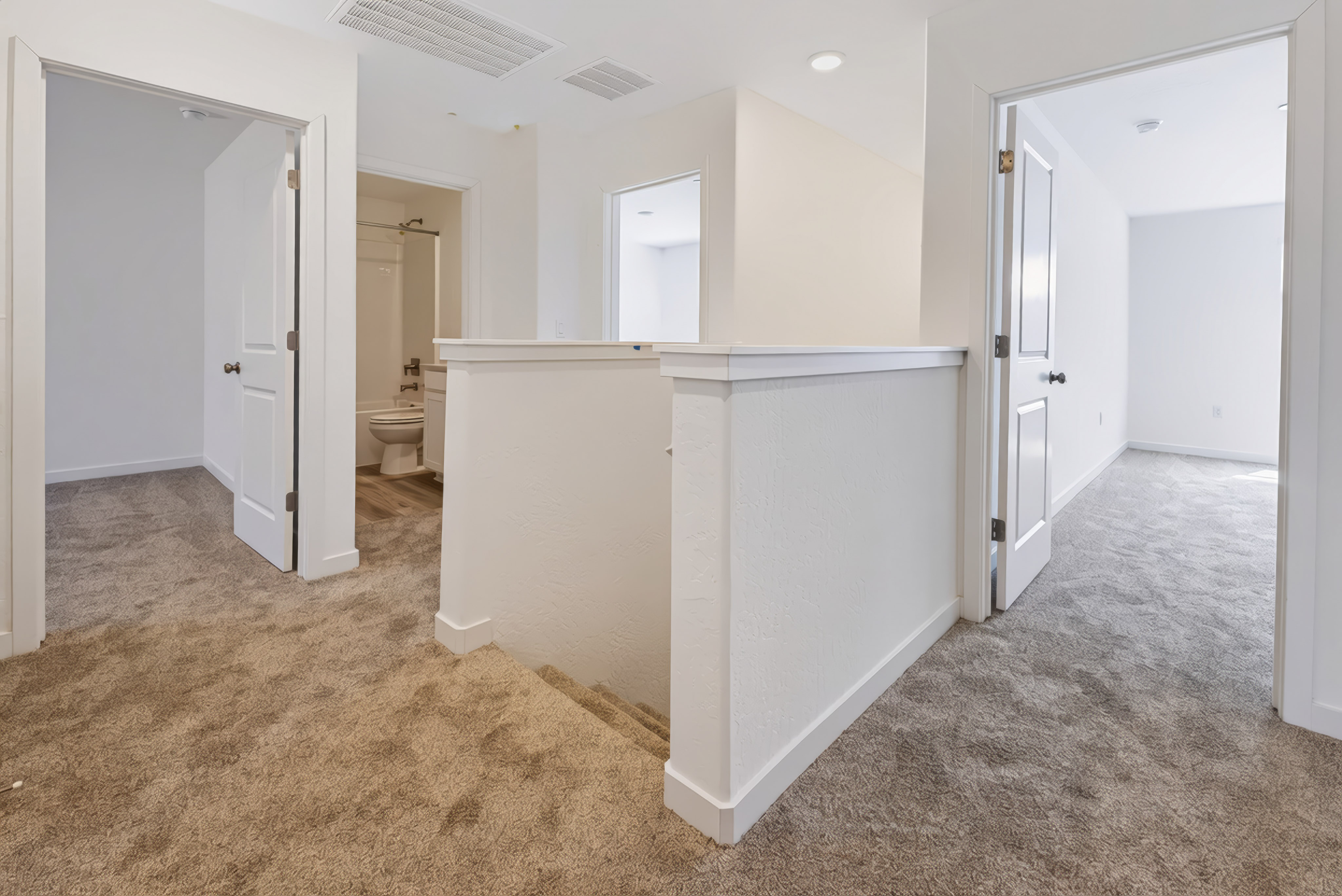 A bathroom with white walls.