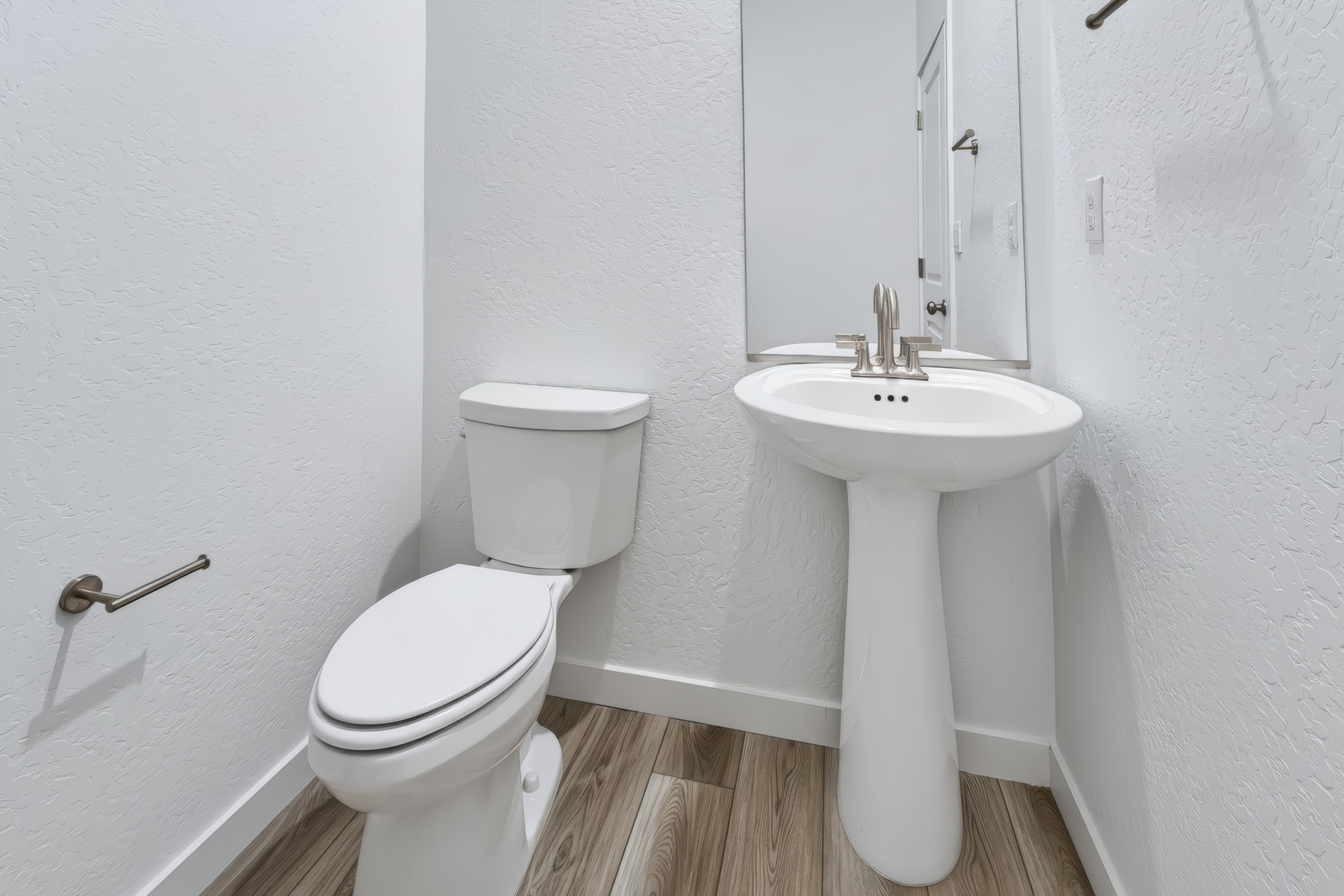 A bathroom with a toilet and sink.