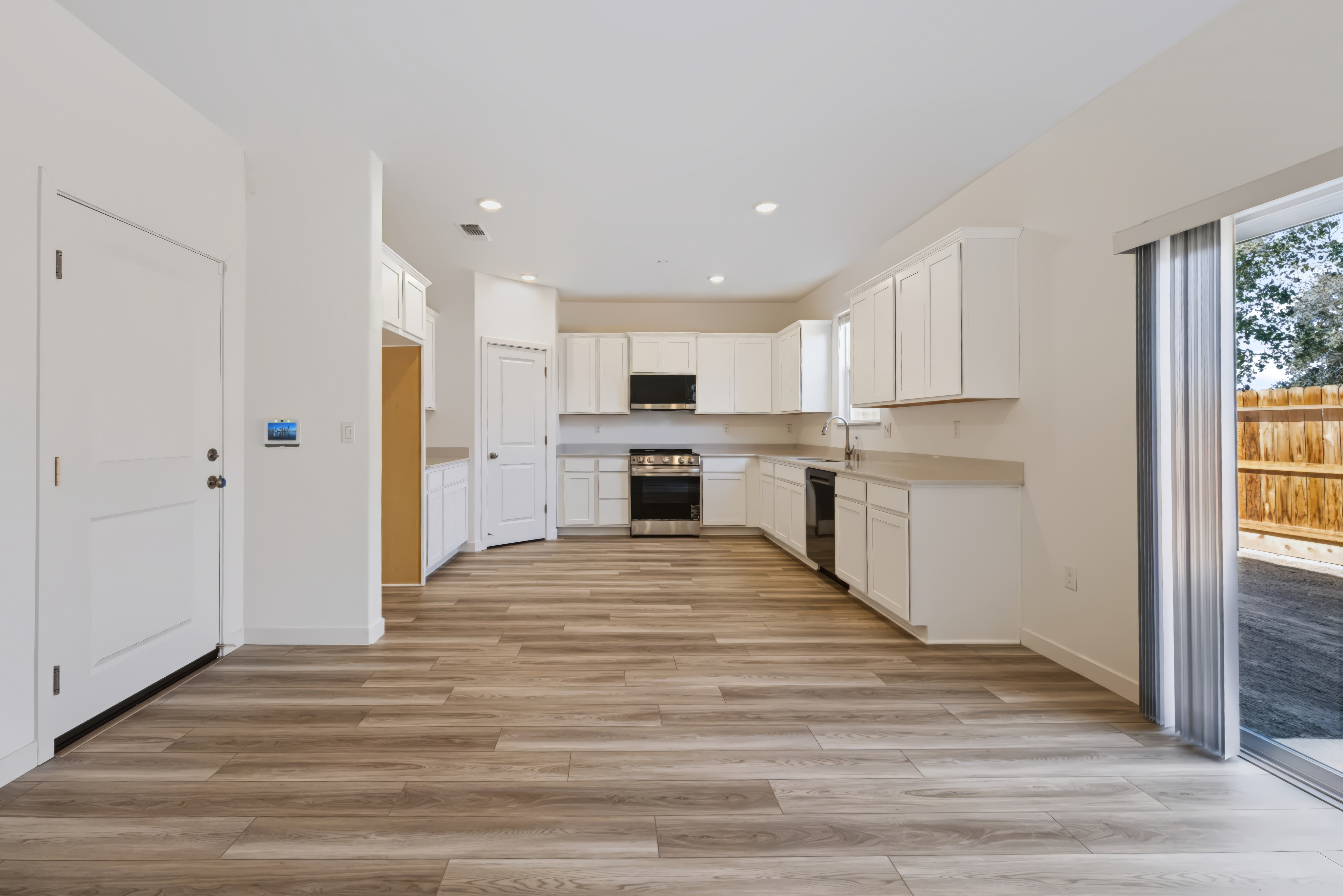 A kitchen with white cabinets.