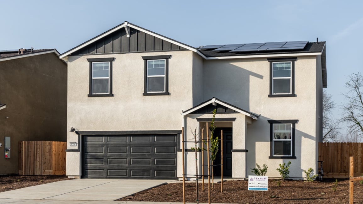 A grey house with a garage.