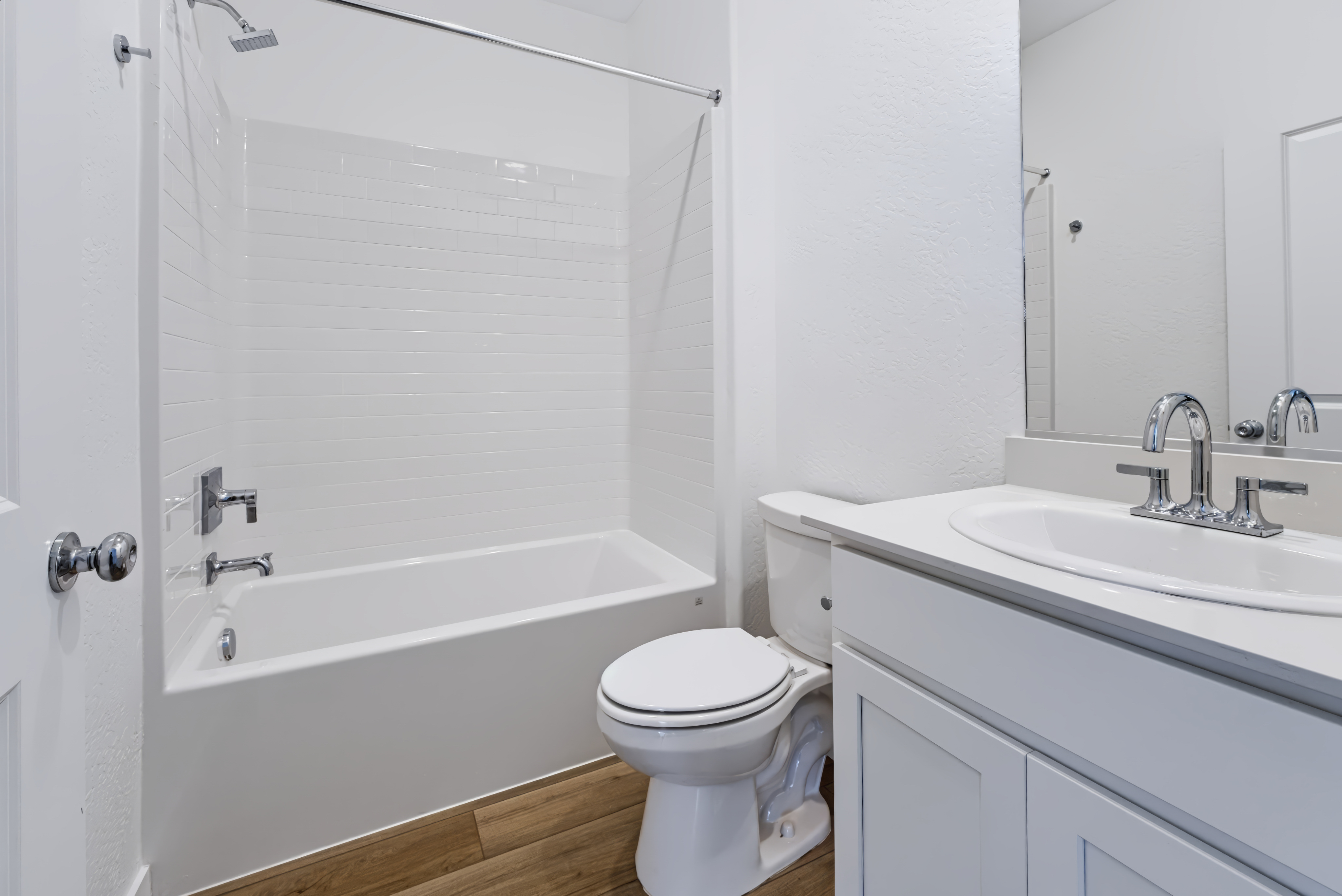 A bathroom with a tub sink and toilet.