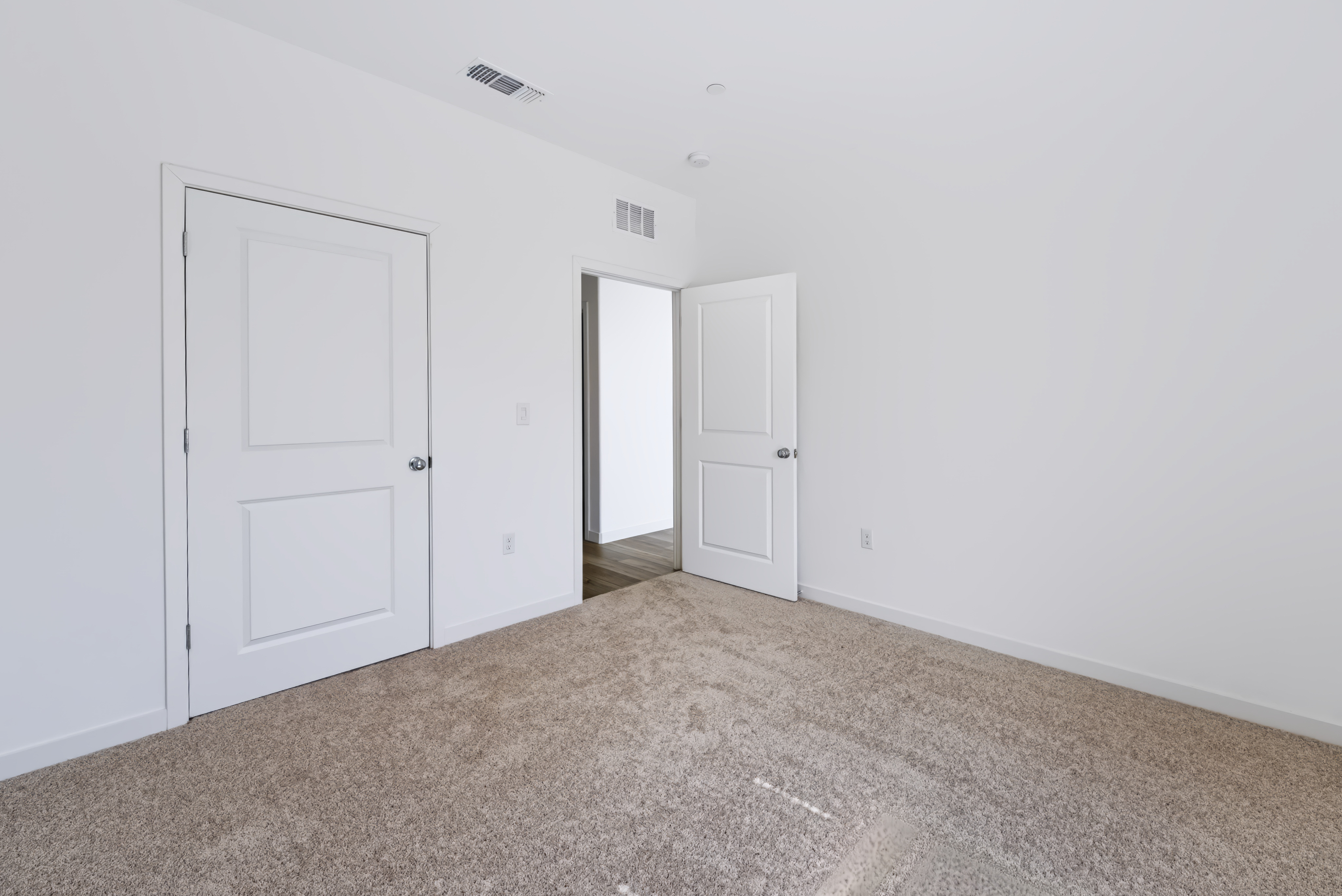 A hallway with white doors.