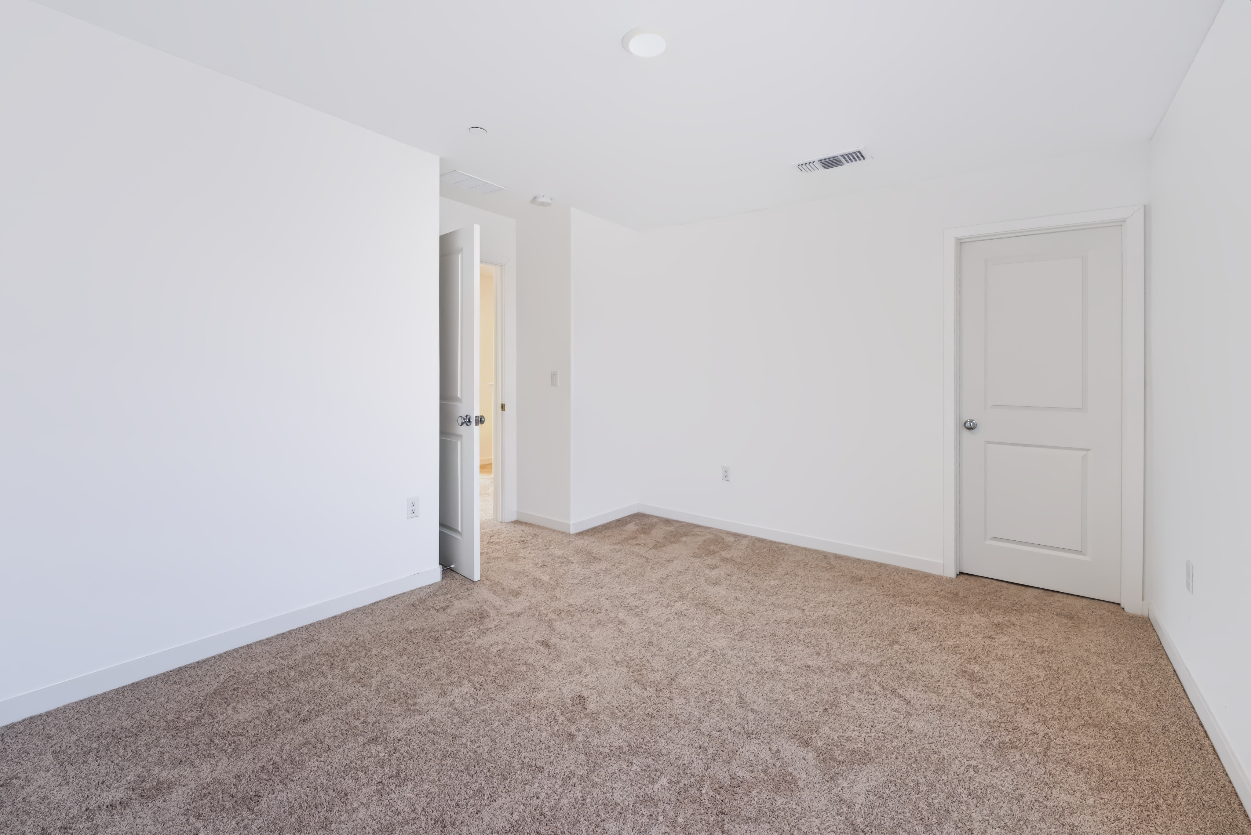 A hallway with white doors.