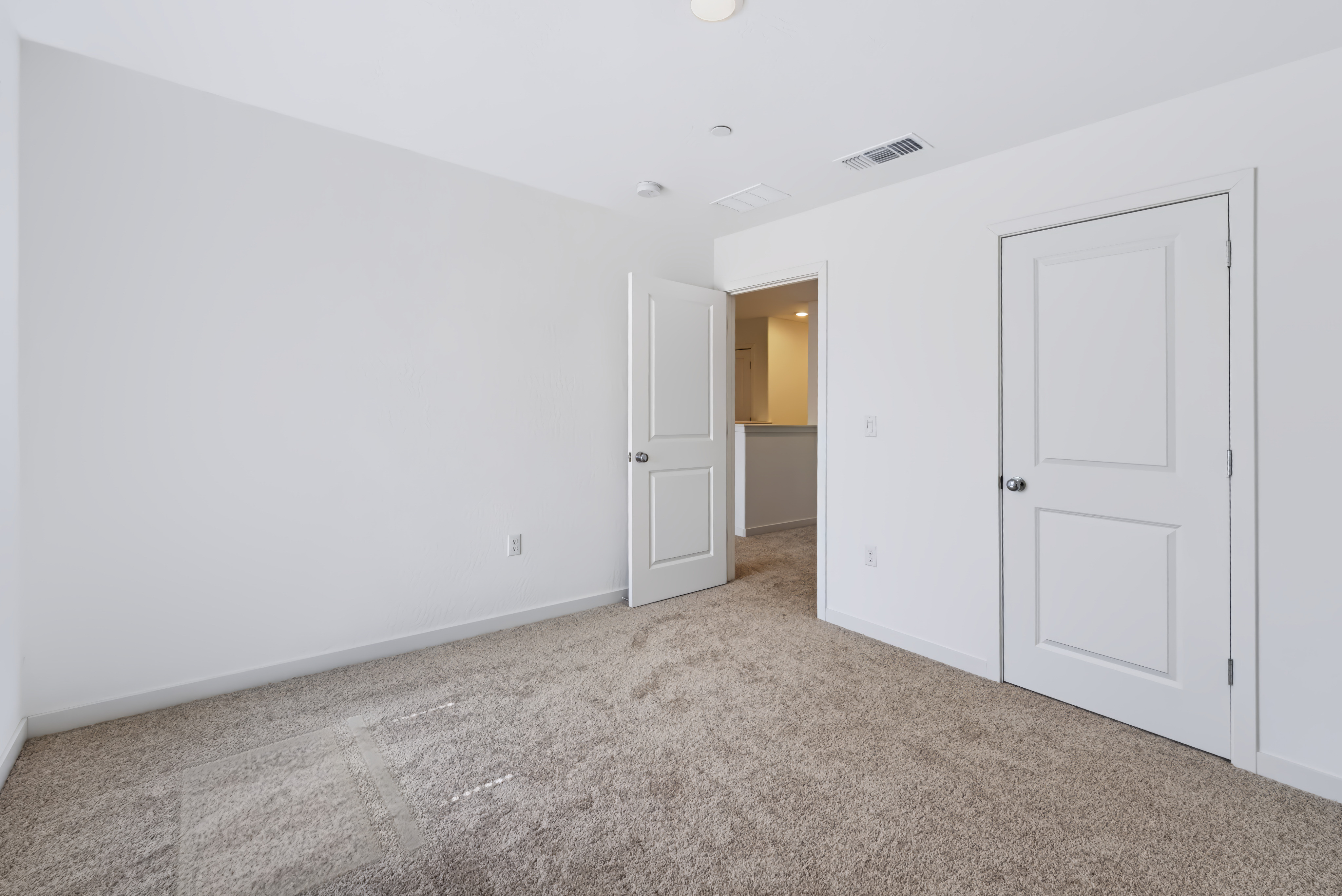 A hallway with white doors.