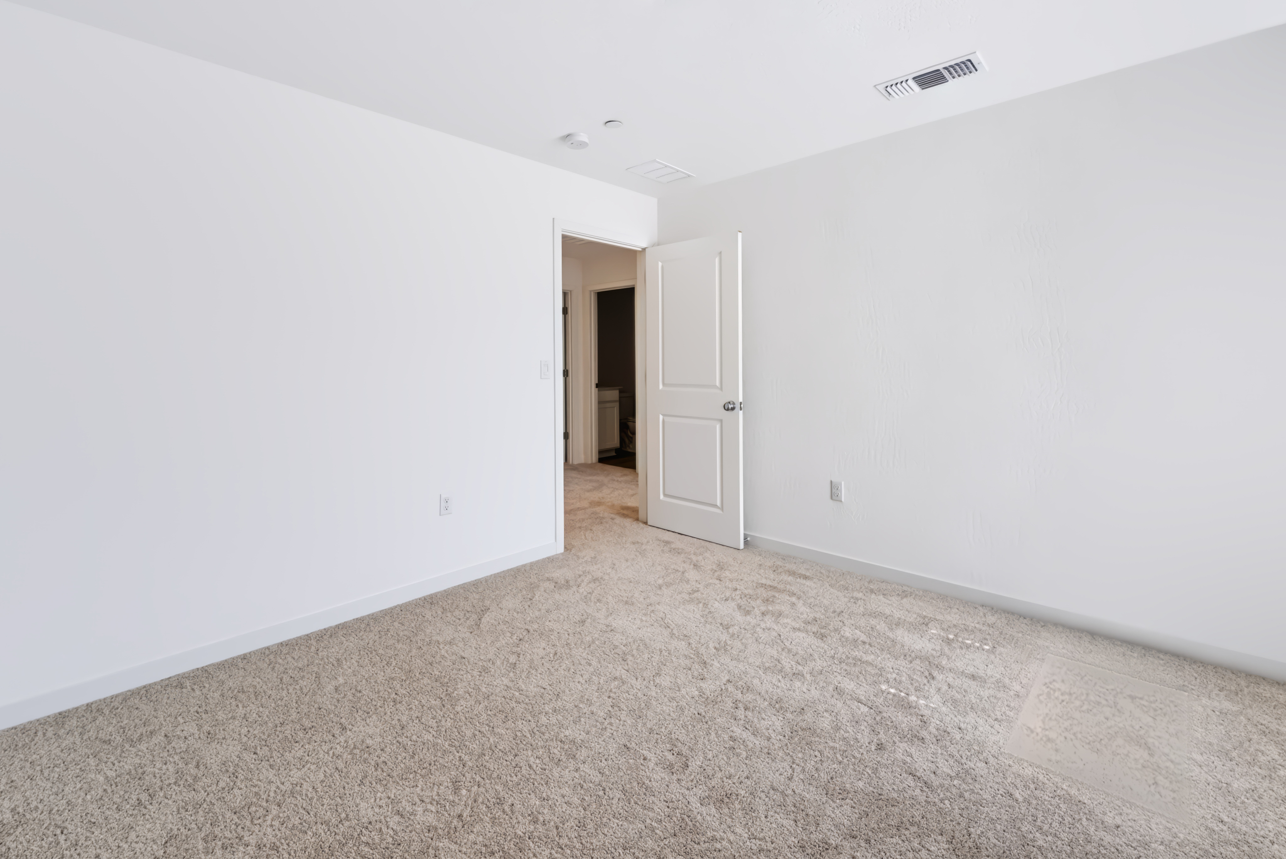 A hallway with white walls.