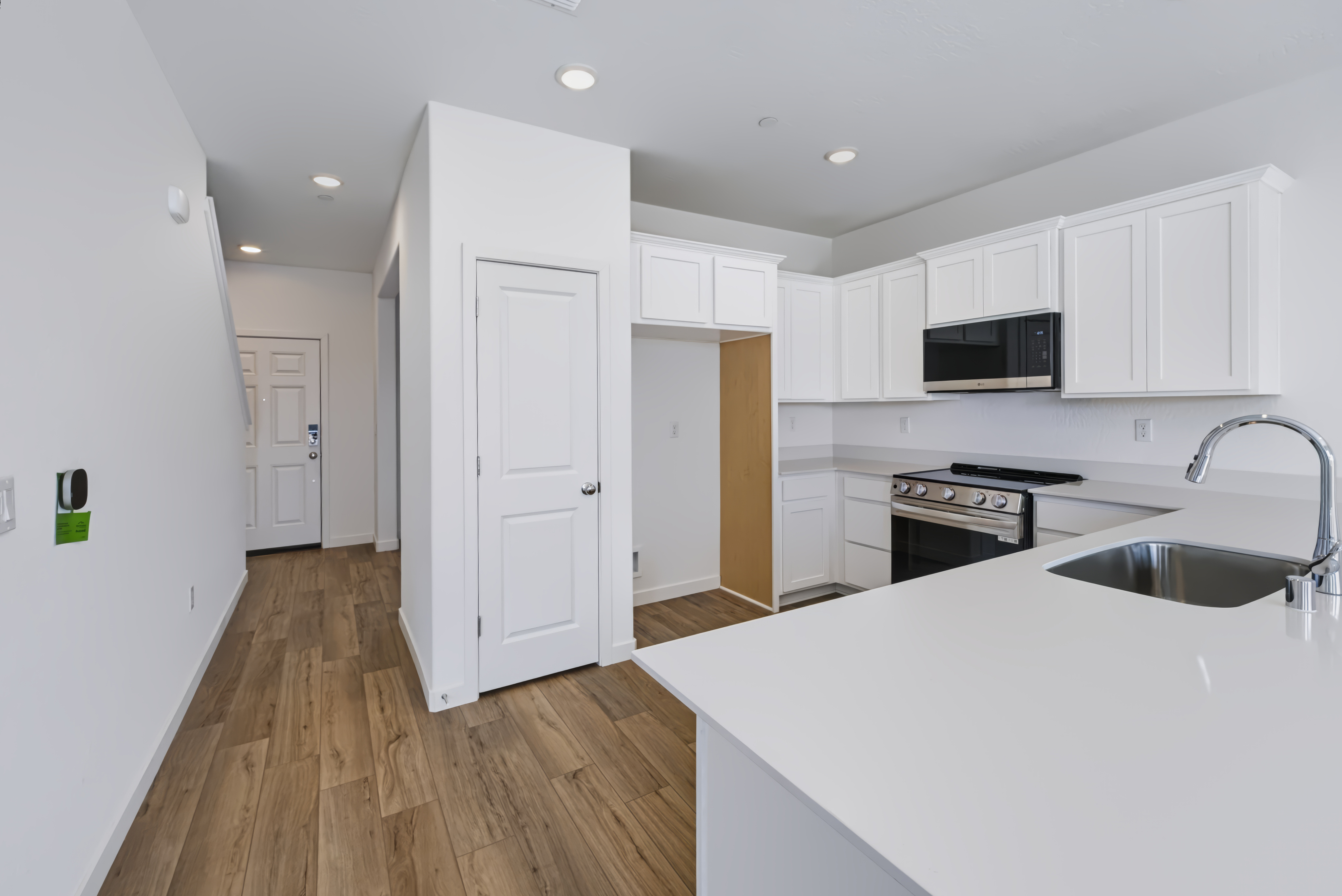 A kitchen with white cabinets.