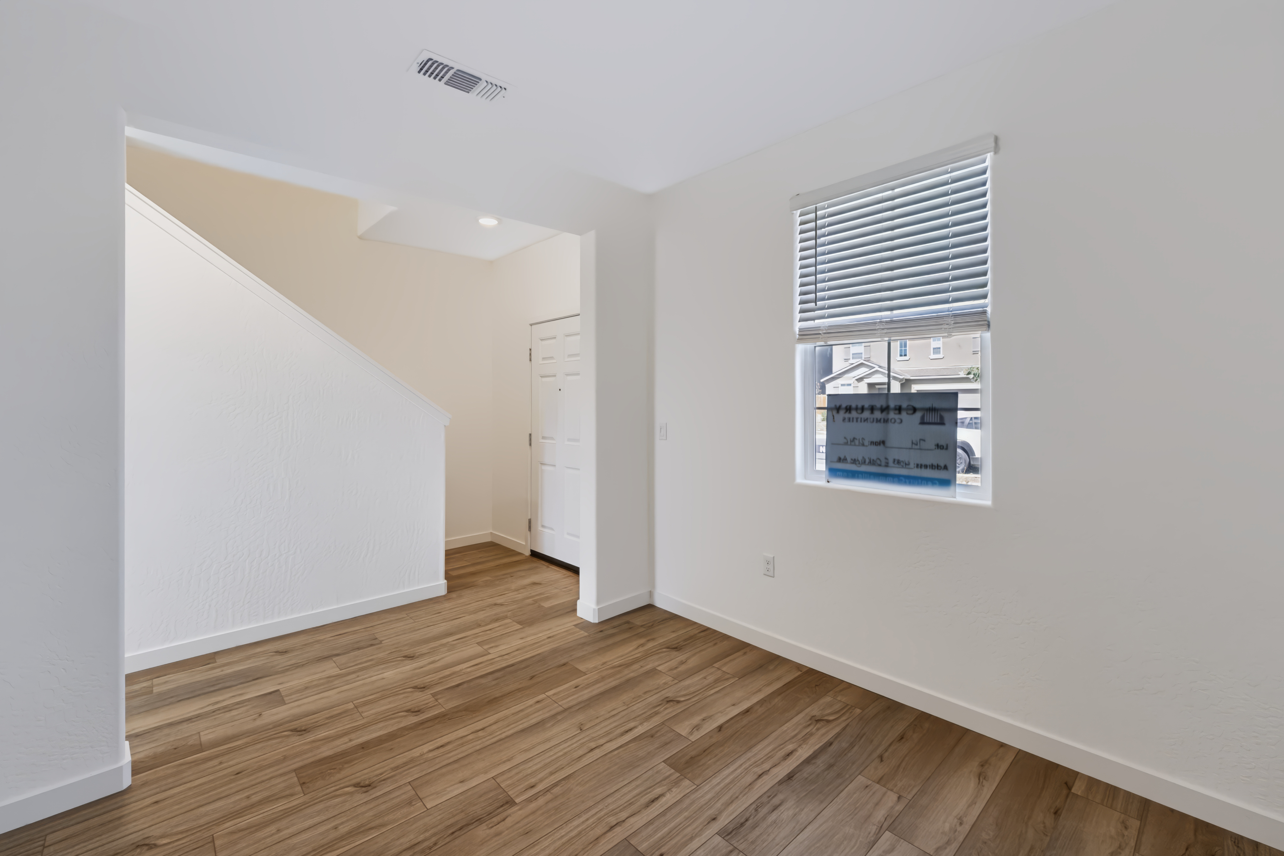 A room with a wood floor and a window.