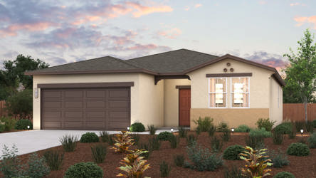 A house with a garage and bushes in front of it.
