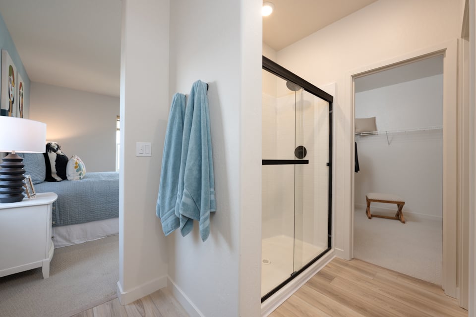 A bathroom with a glass door.