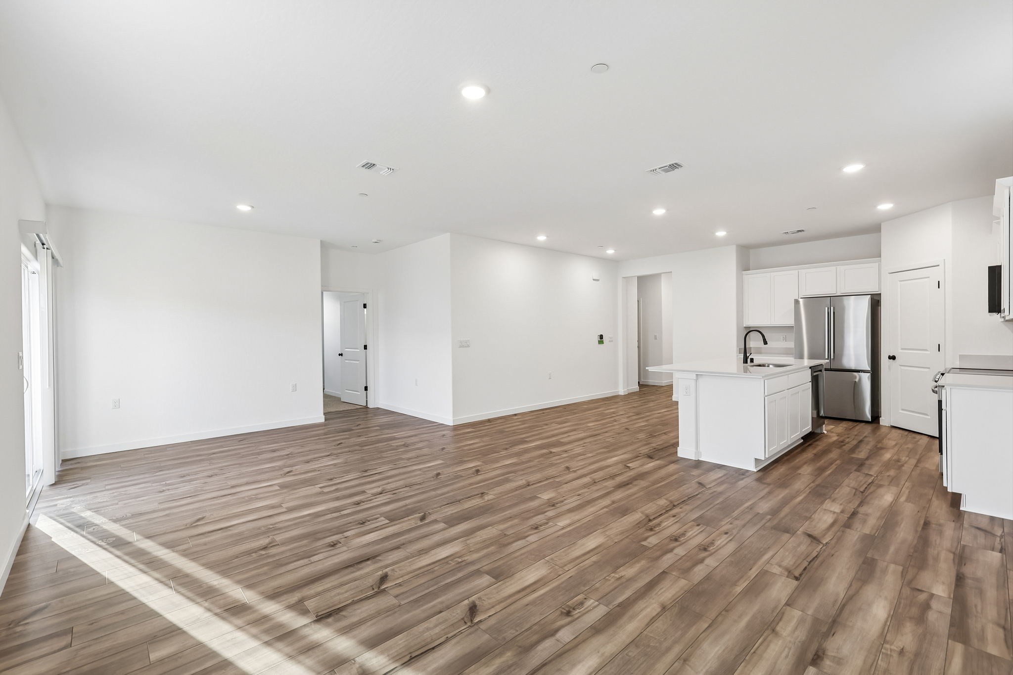 A large kitchen with white cabinets.