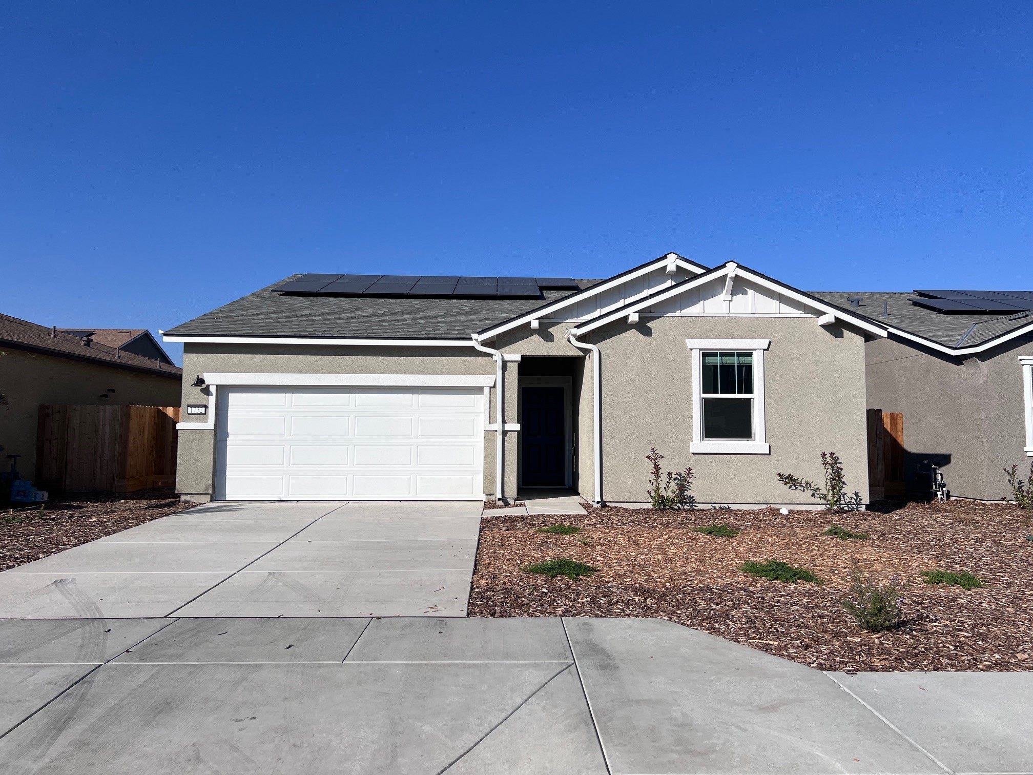 A house with garages and a driveway.