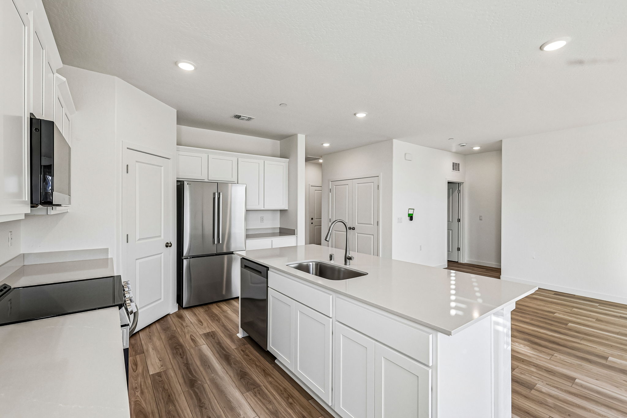 A kitchen with white cabinets.
