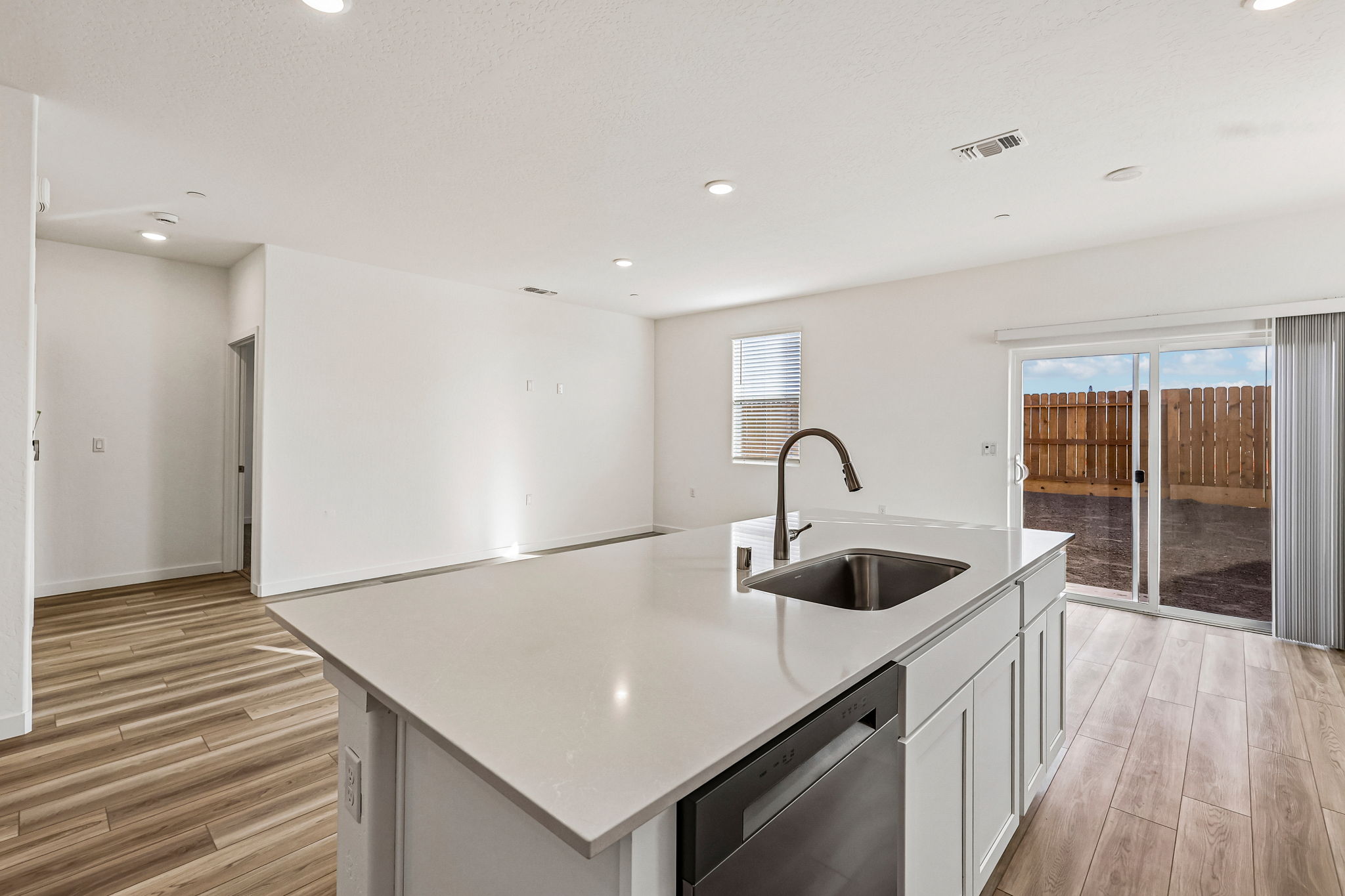A kitchen with a sink and a large window.