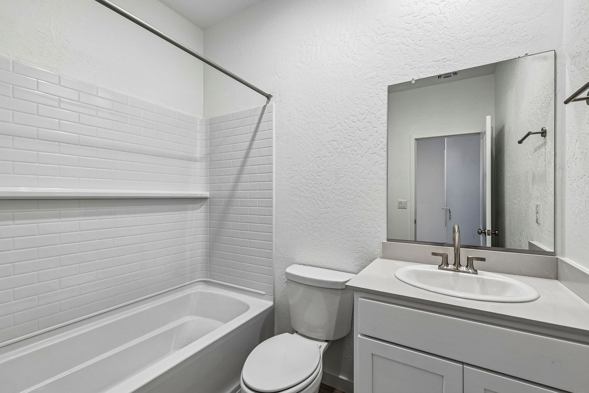 A bathroom with a sink toilet and bathtub.