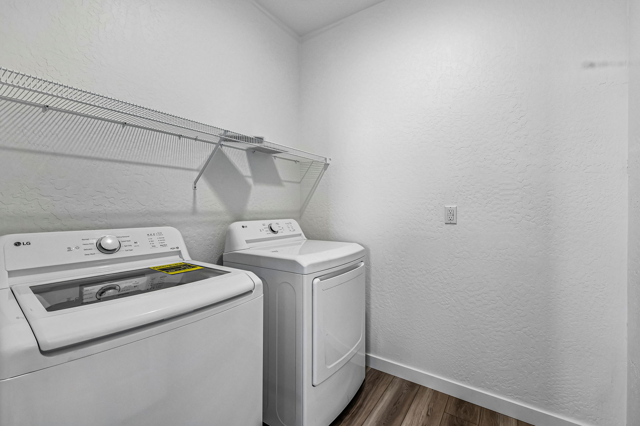 A washing machine and dryer in a room.