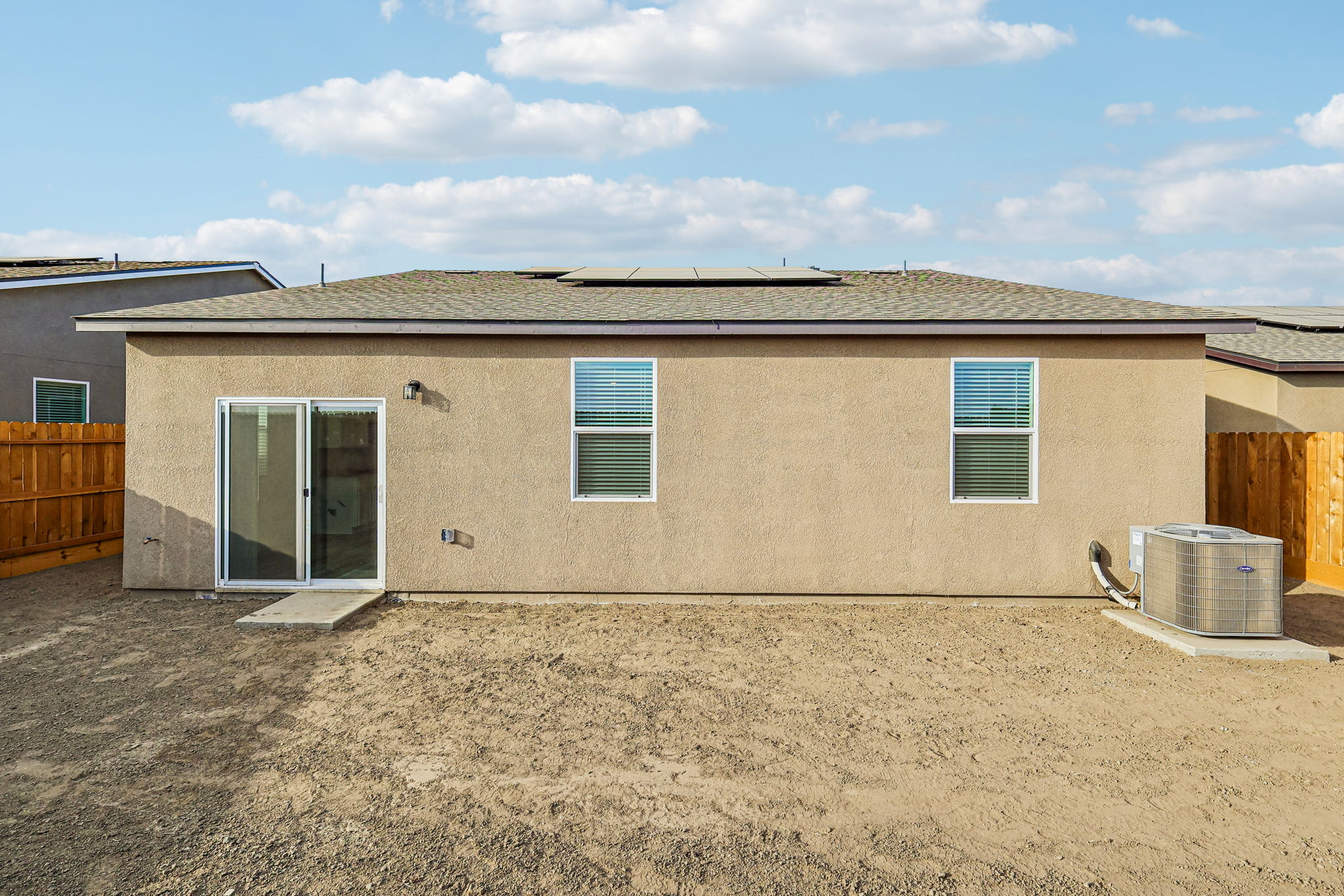 A house with a dirt yard.