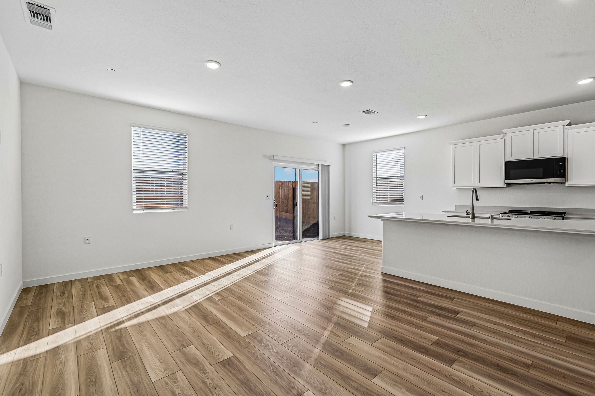 A room with white walls and a wood floor.