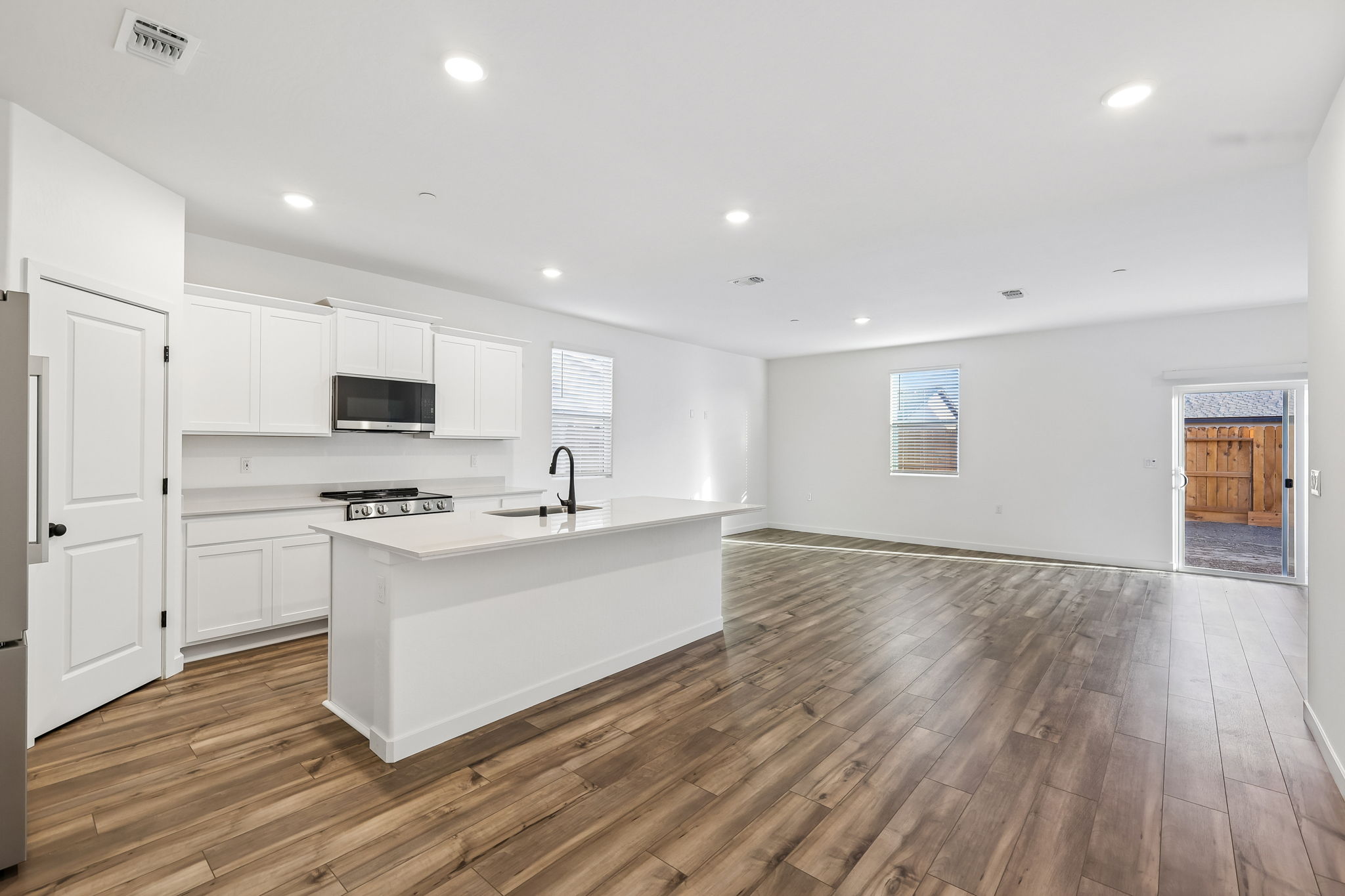 A kitchen with white cabinets.