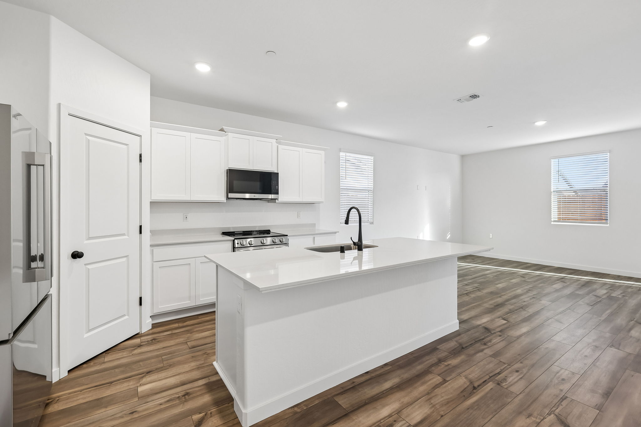 A kitchen with white cabinets.