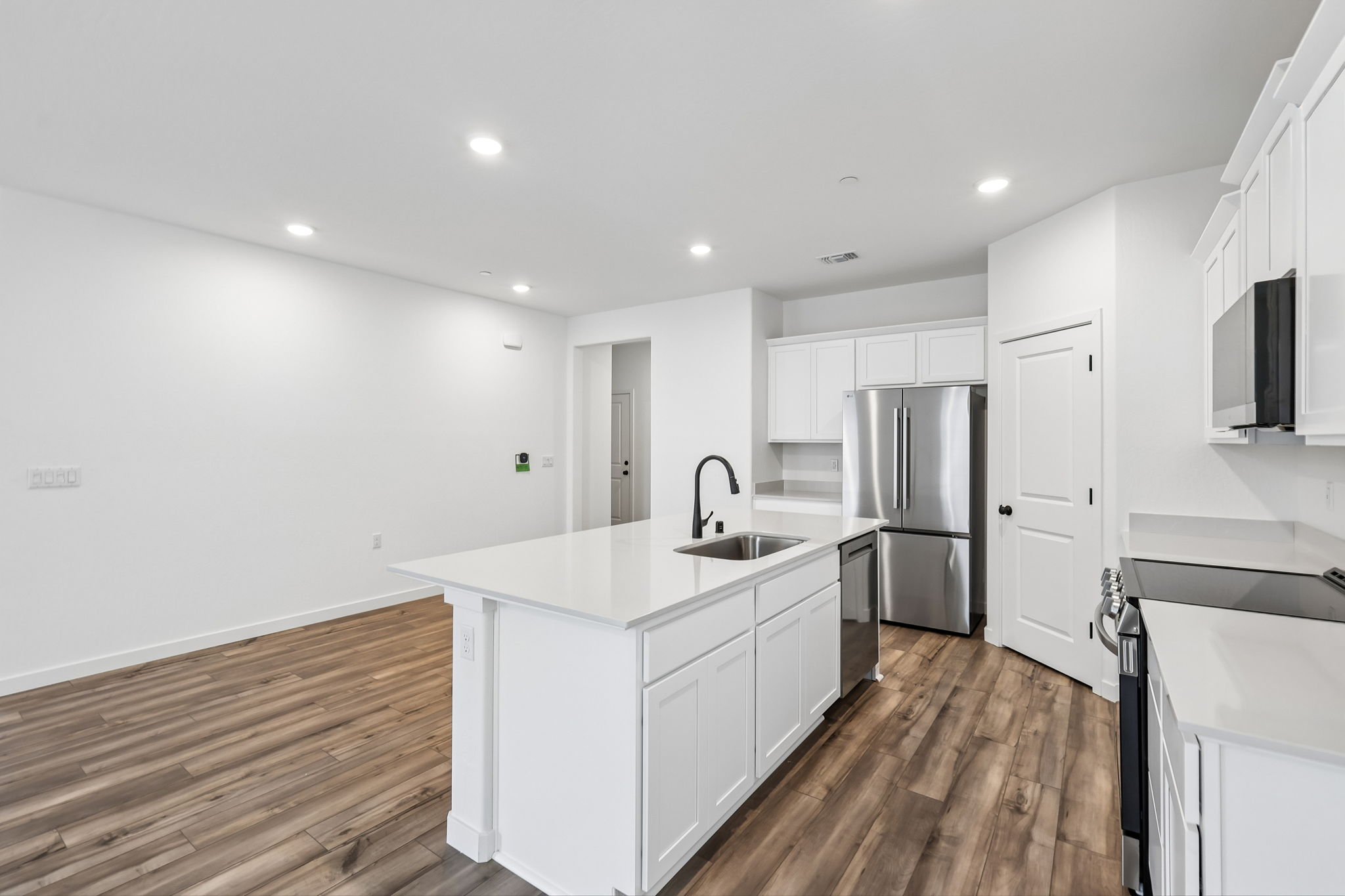 A kitchen with white cabinets.