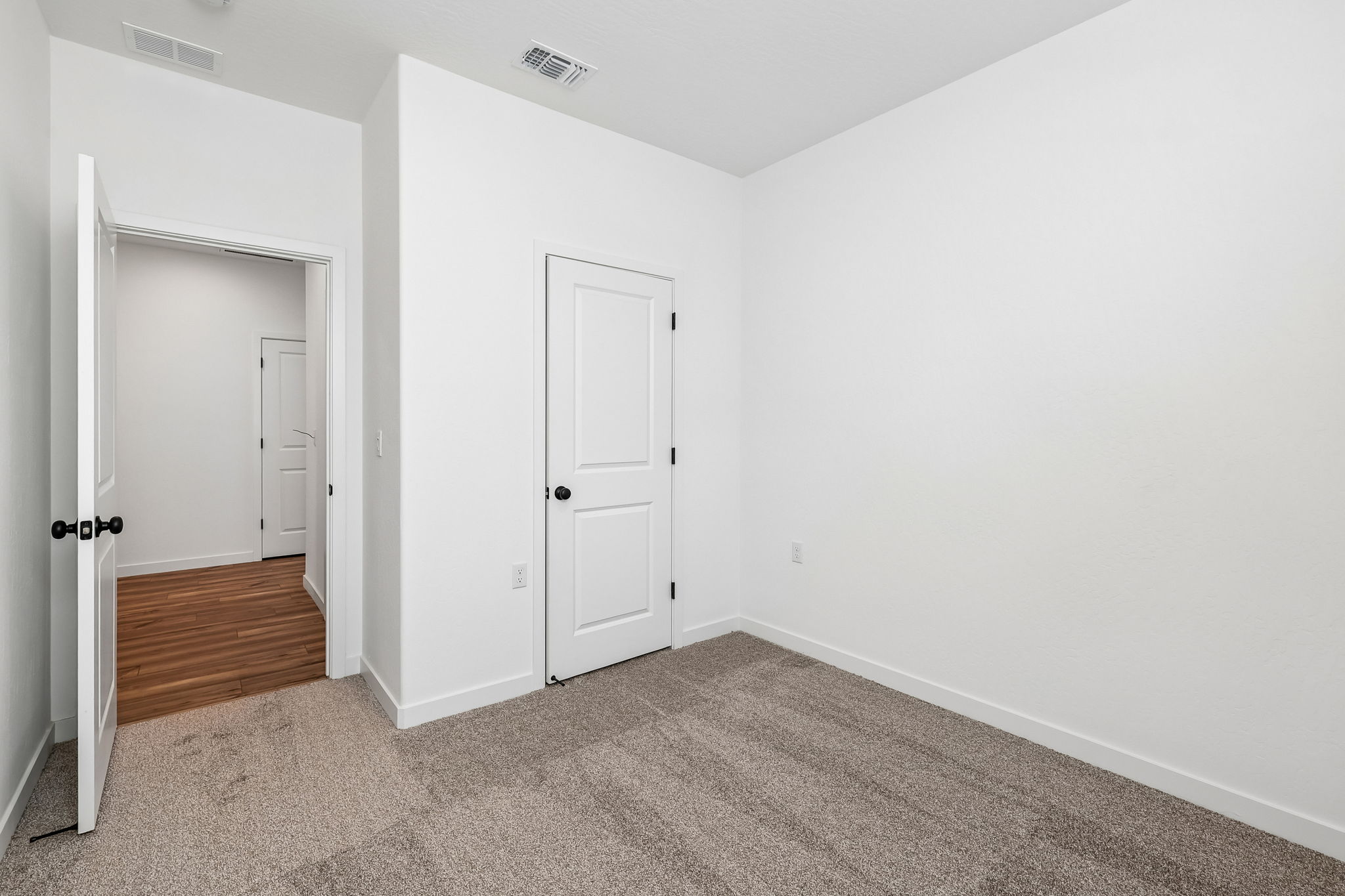 A hallway with white doors.