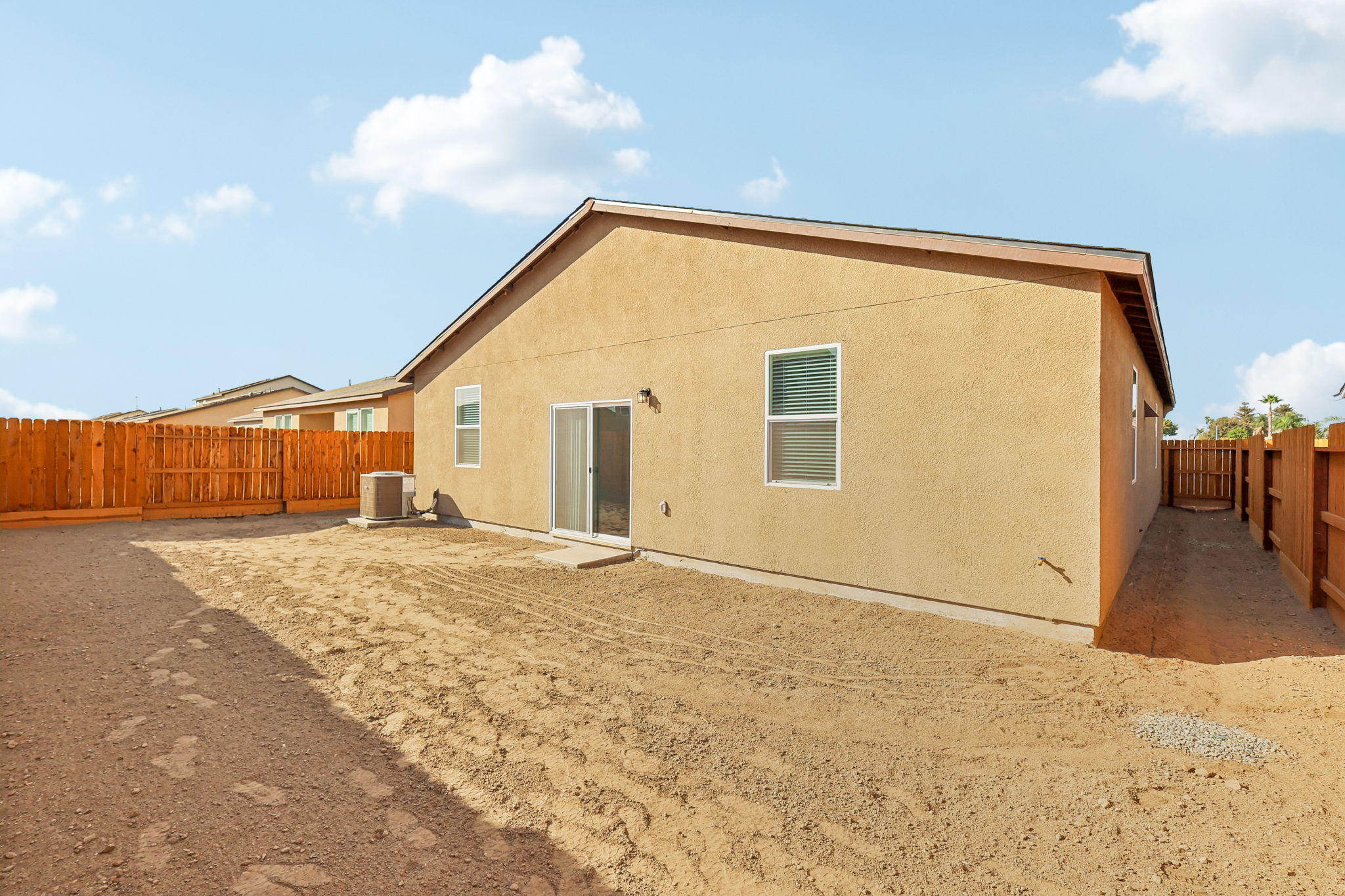 A house with a dirt road.