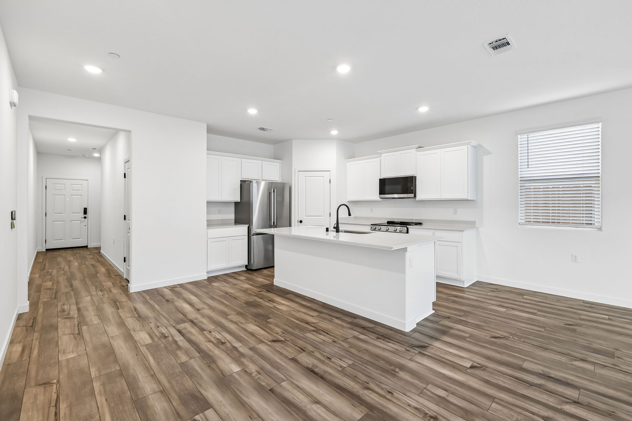 A kitchen with white cabinets.